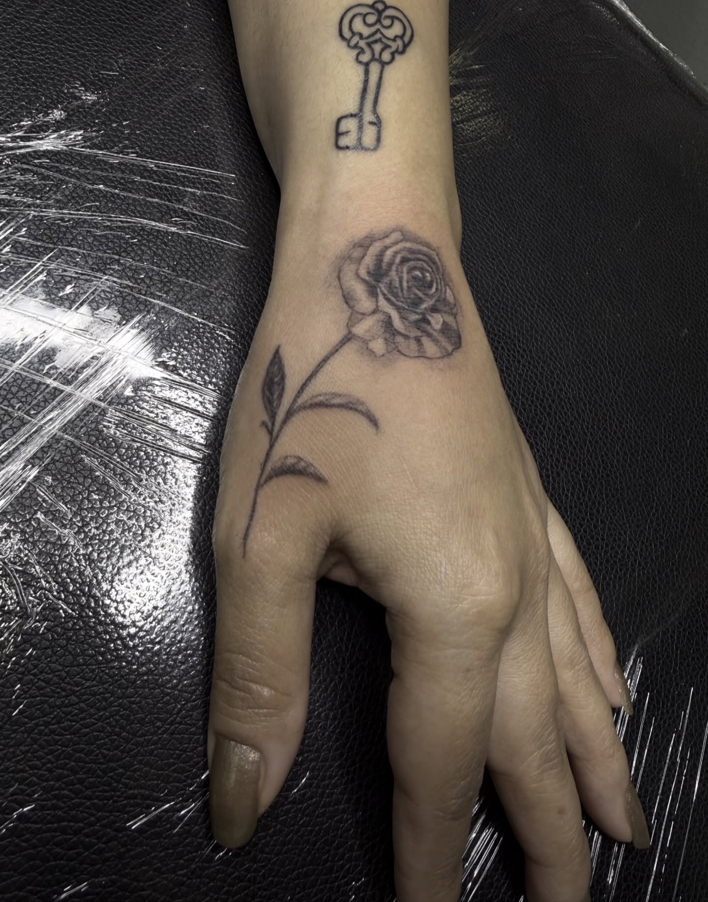 Rose and key black and grey tattoo on the forearm by Healoha “Lindelle” Kamanu