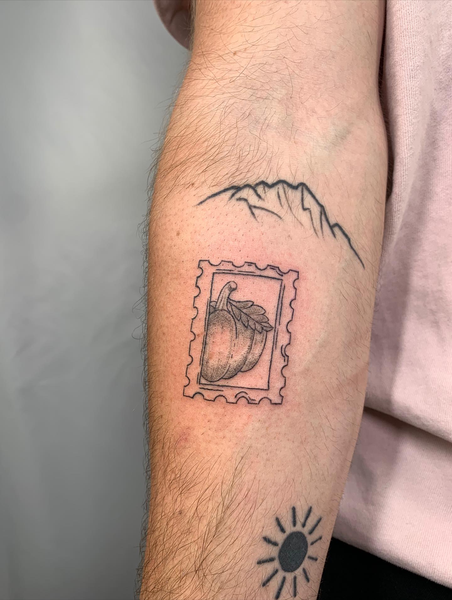 Pumpkin postage stamp black and grey tattoo on the forearm by ⊹ Avery Peterson ⊹