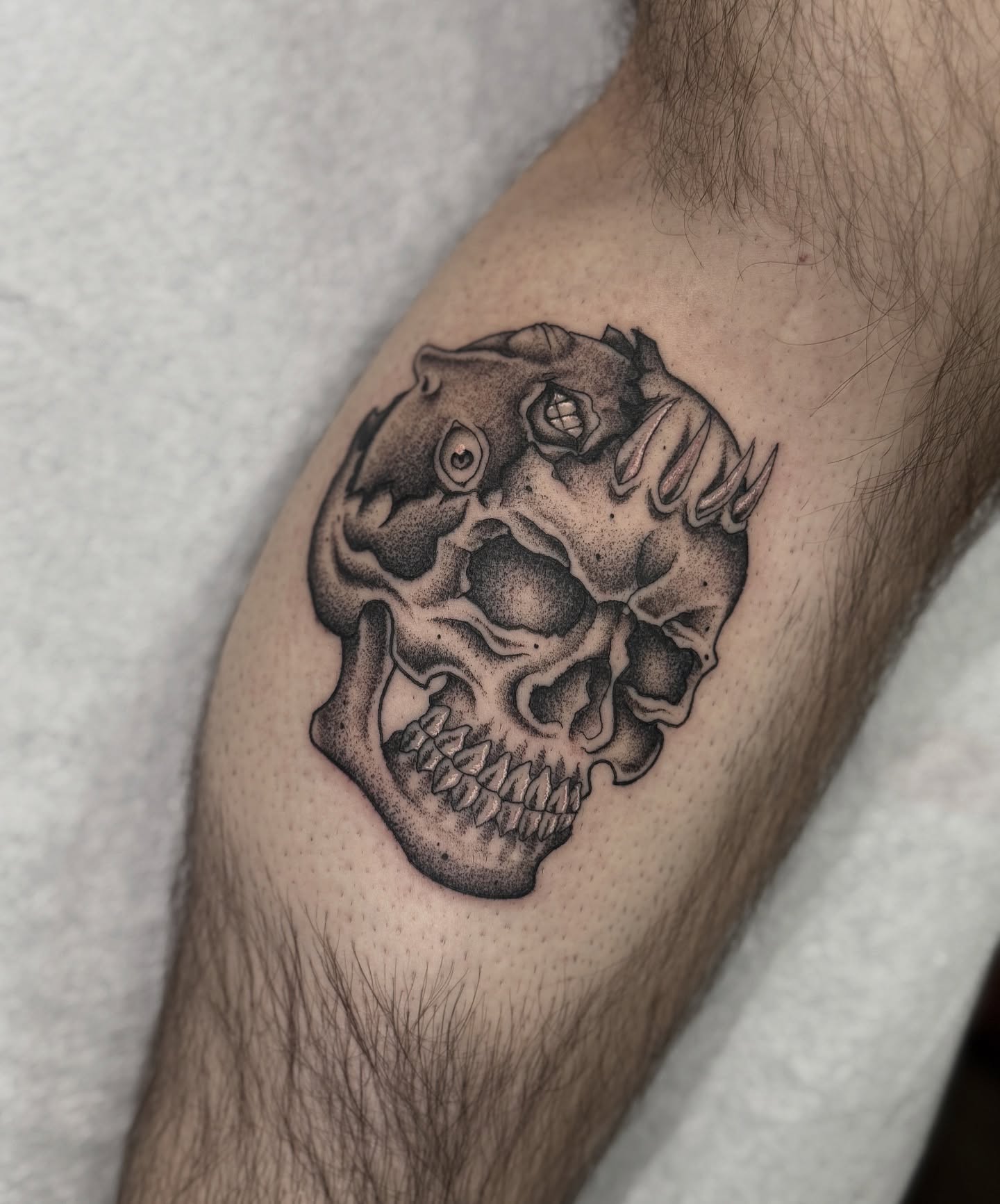 Skull dotwork tattoo on the forearm by Andrew