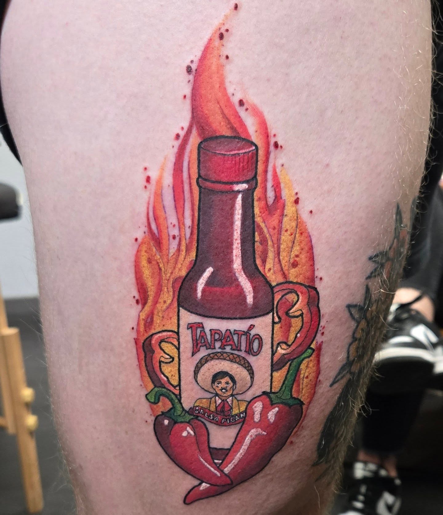 Tapatio hot sauce bottle realism tattoo on the thigh by Brian Savage, Gilbert, Arizona