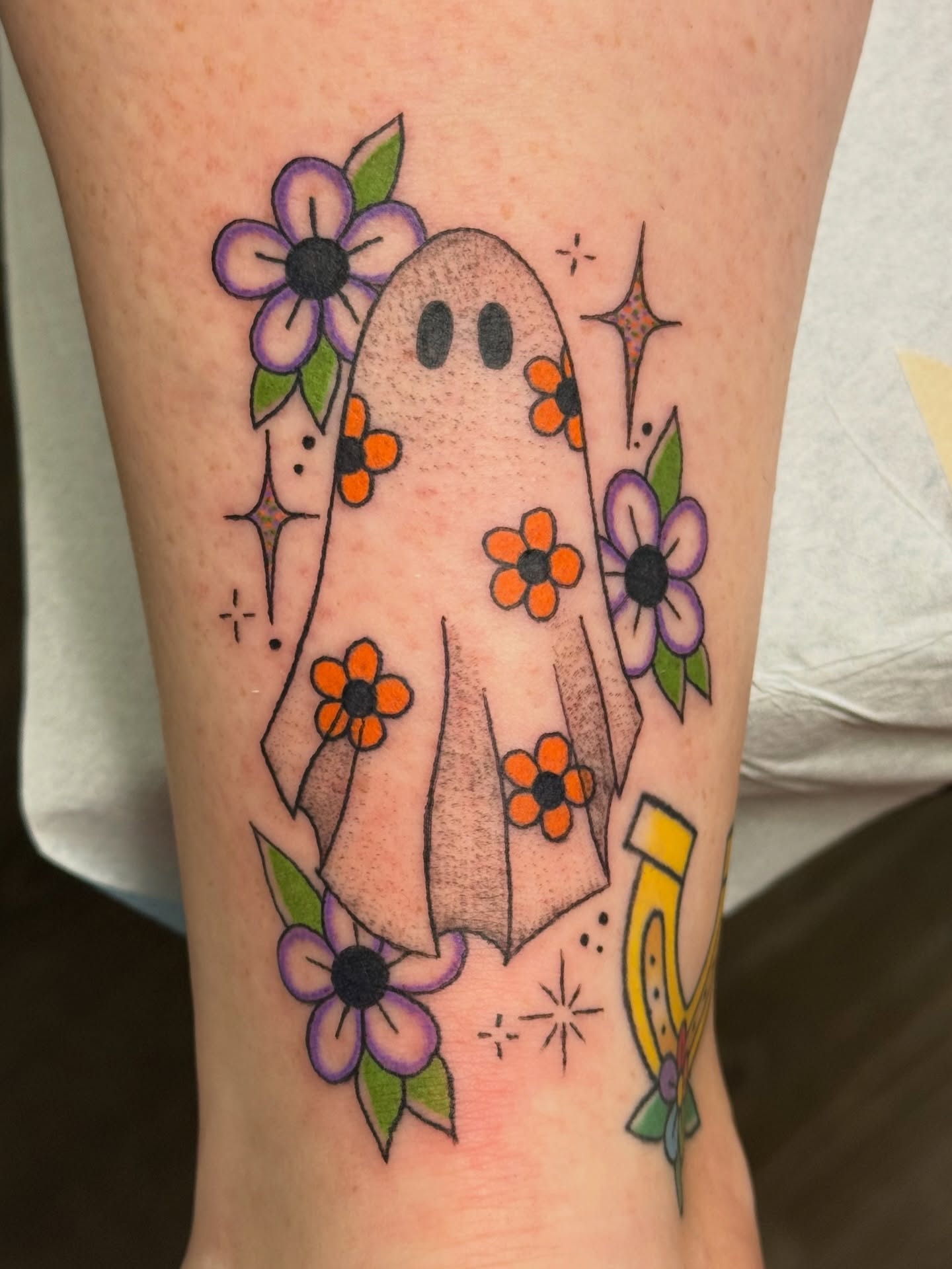 Ghost with flowers American traditional tattoo on the forearm by Alexx Colombo