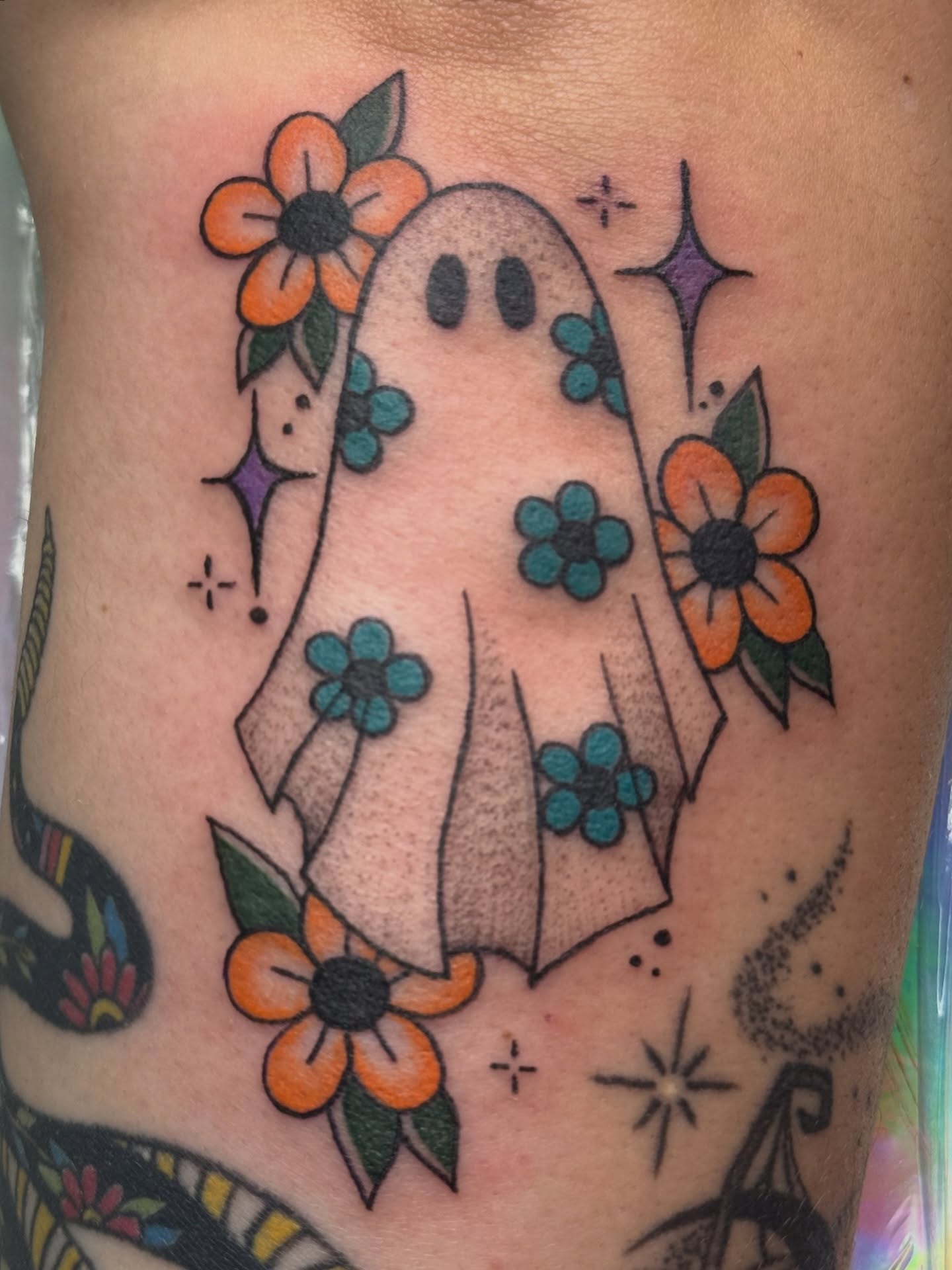 Ghost with flowers American traditional tattoo on the thigh by Alexx Colombo