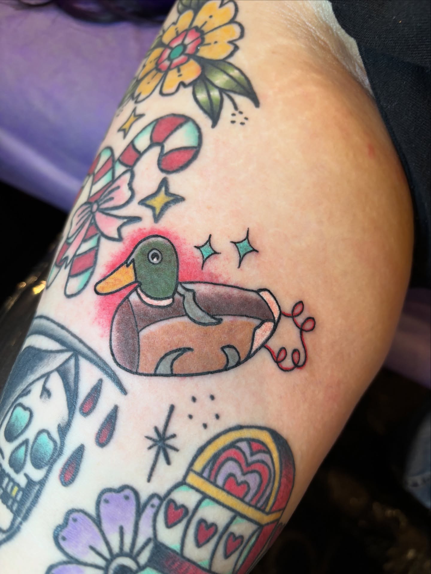 Duck in life jacket American traditional tattoo on the upper arm by Malia Clark