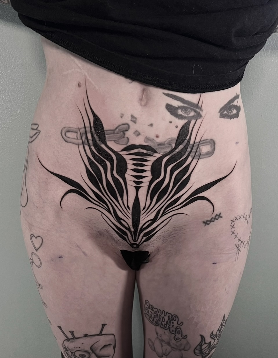 Mask black and grey tattoo on the thigh by ༒ boniandi༒