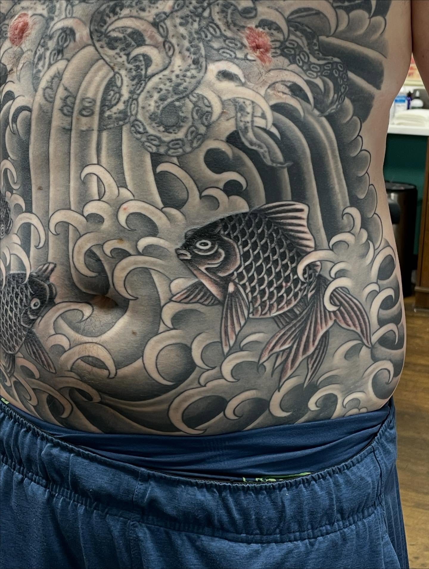 Koi fish japanese irezumi tattoo on the torso by Haley McMahon