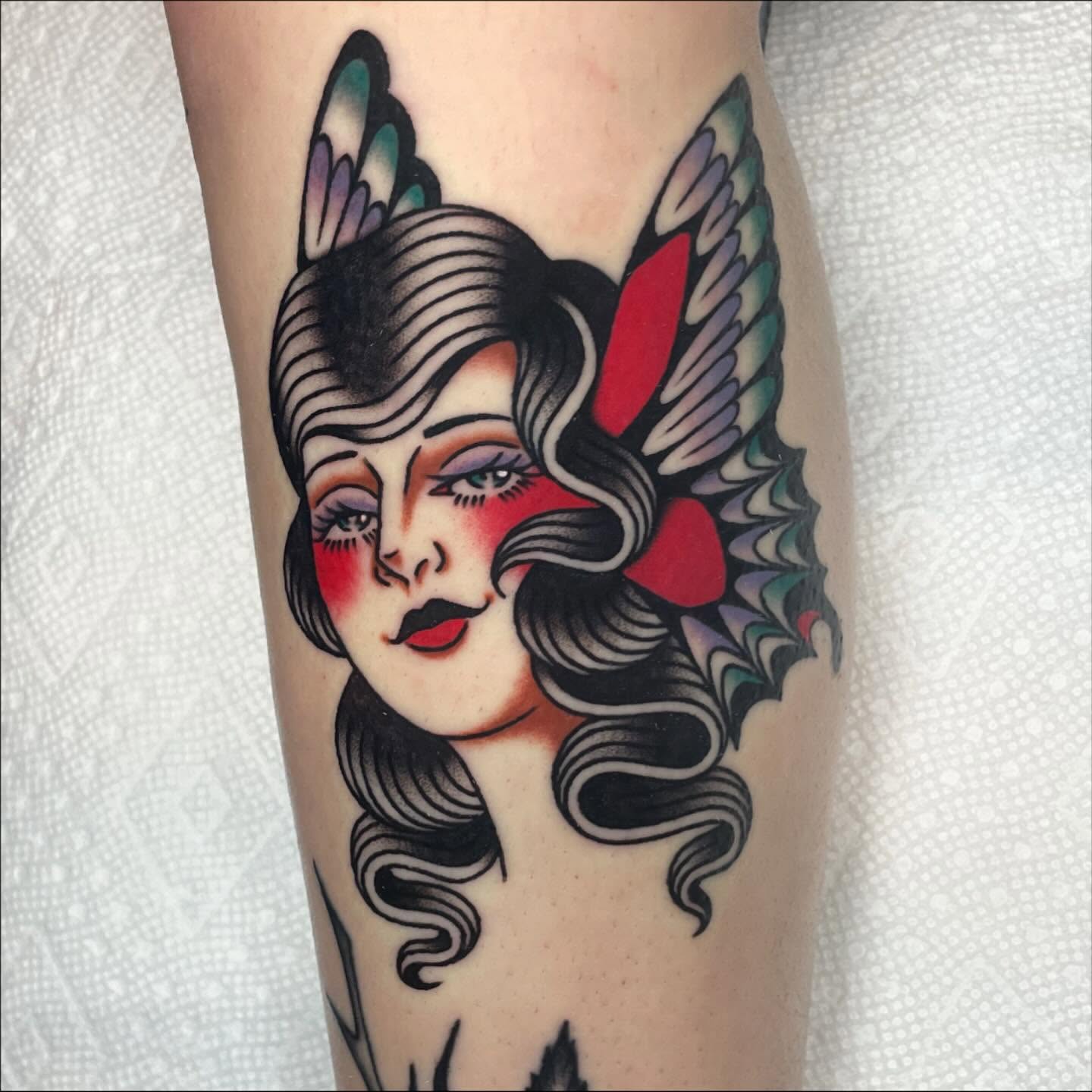 Woman with wings American traditional tattoo on the forearm by Nova Vaughn