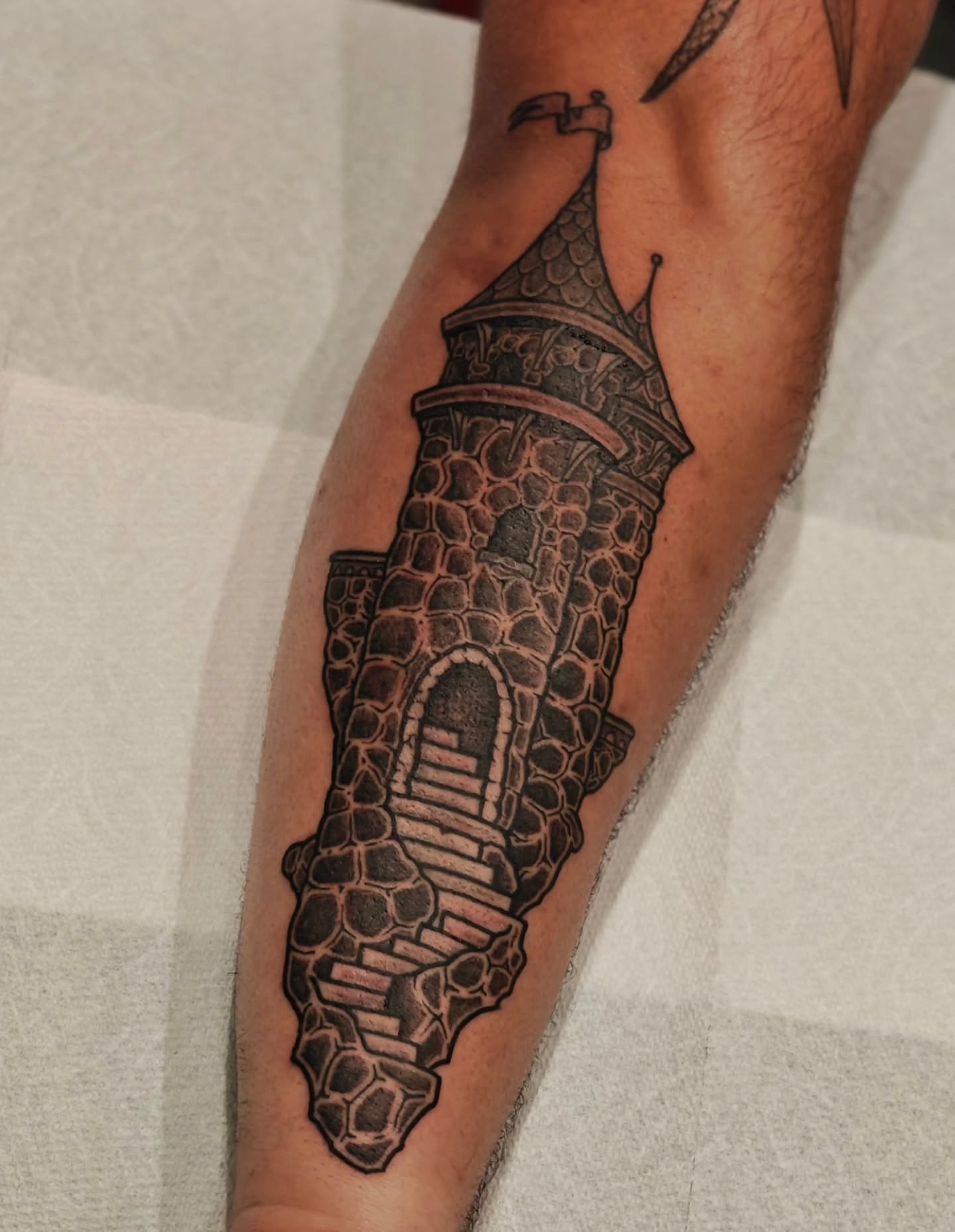 Castle tower black and grey tattoo on the forearm by Tattoos by Reed Blount