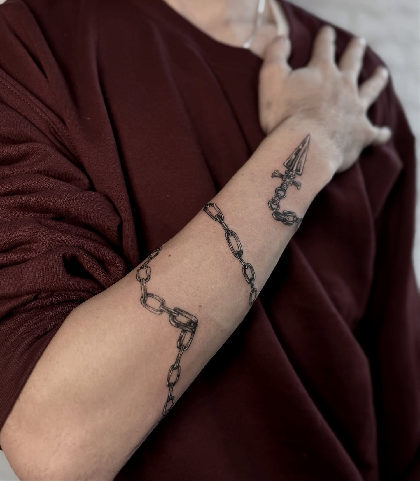 Chain and dagger black and grey tattoo on the forearm by Asia Rene Tattoos👑