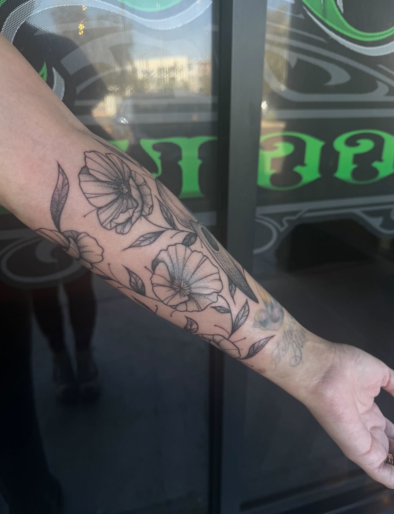 Floral pattern black and grey tattoo on the forearm by Jianna