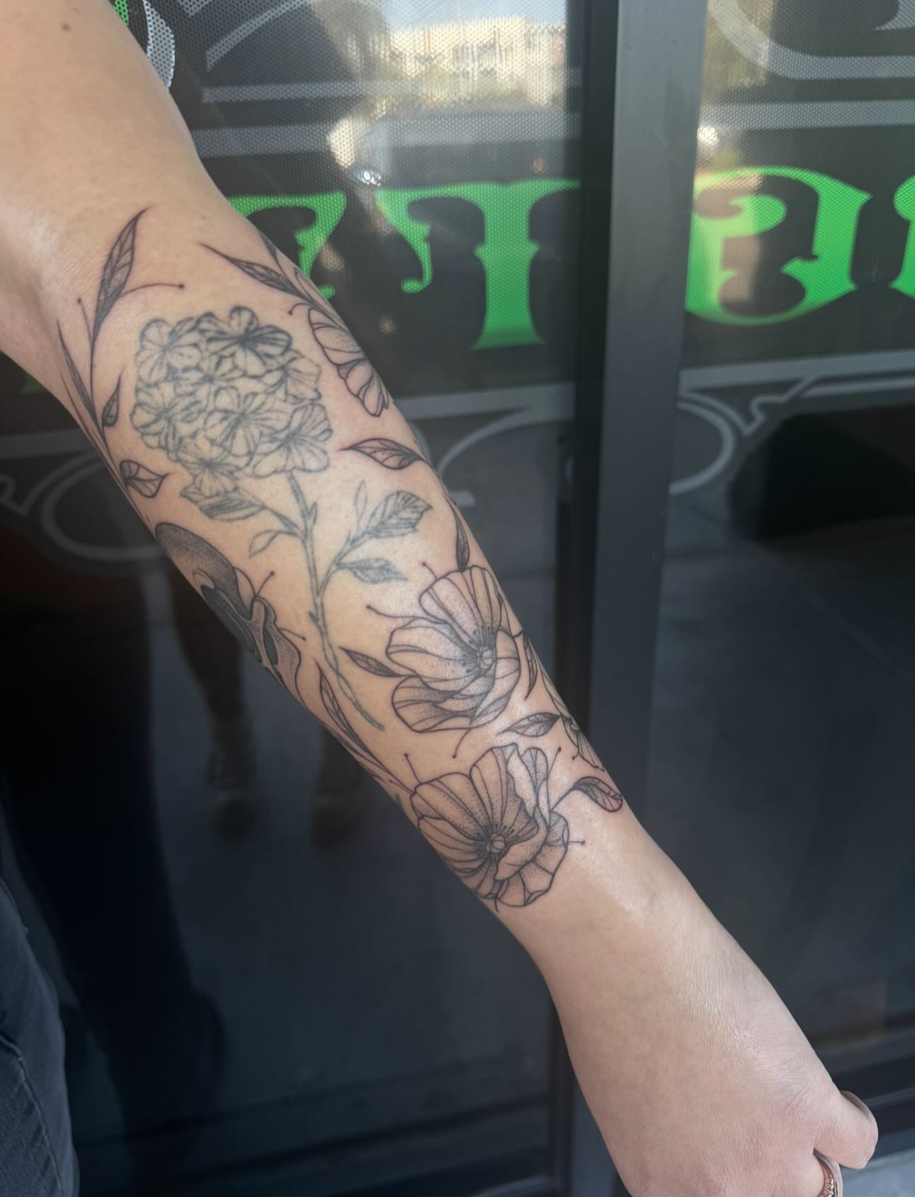 Floral bouquet black and grey tattoo on the forearm by Jianna