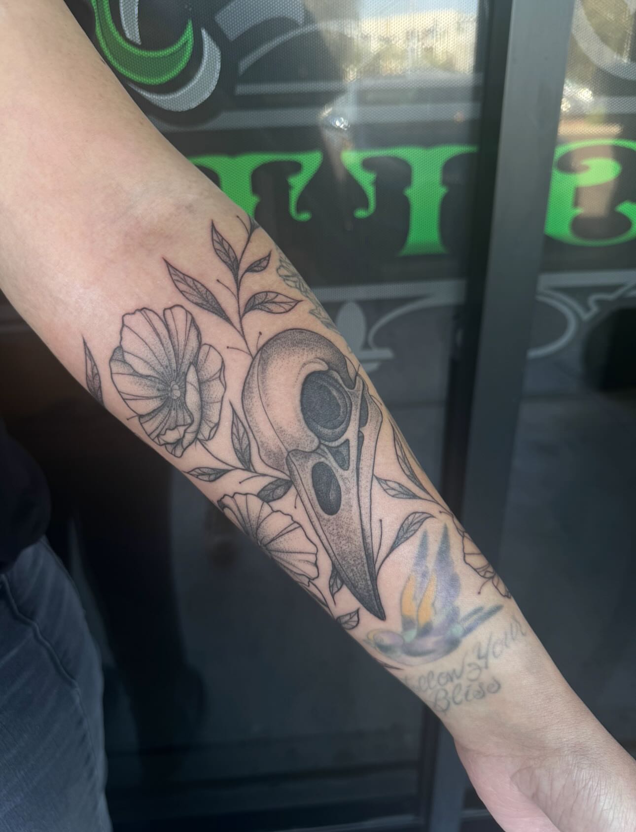 Skull and flowers dotwork tattoo on the forearm by Jianna