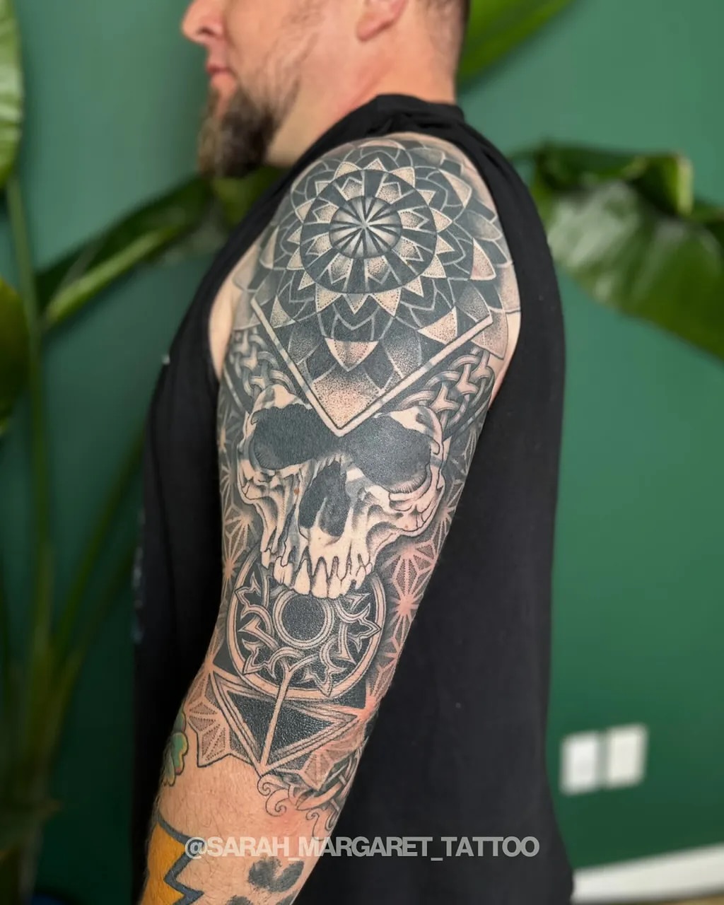 Geometric skull geometric tattoo on the upper arm by Sarah Margaret