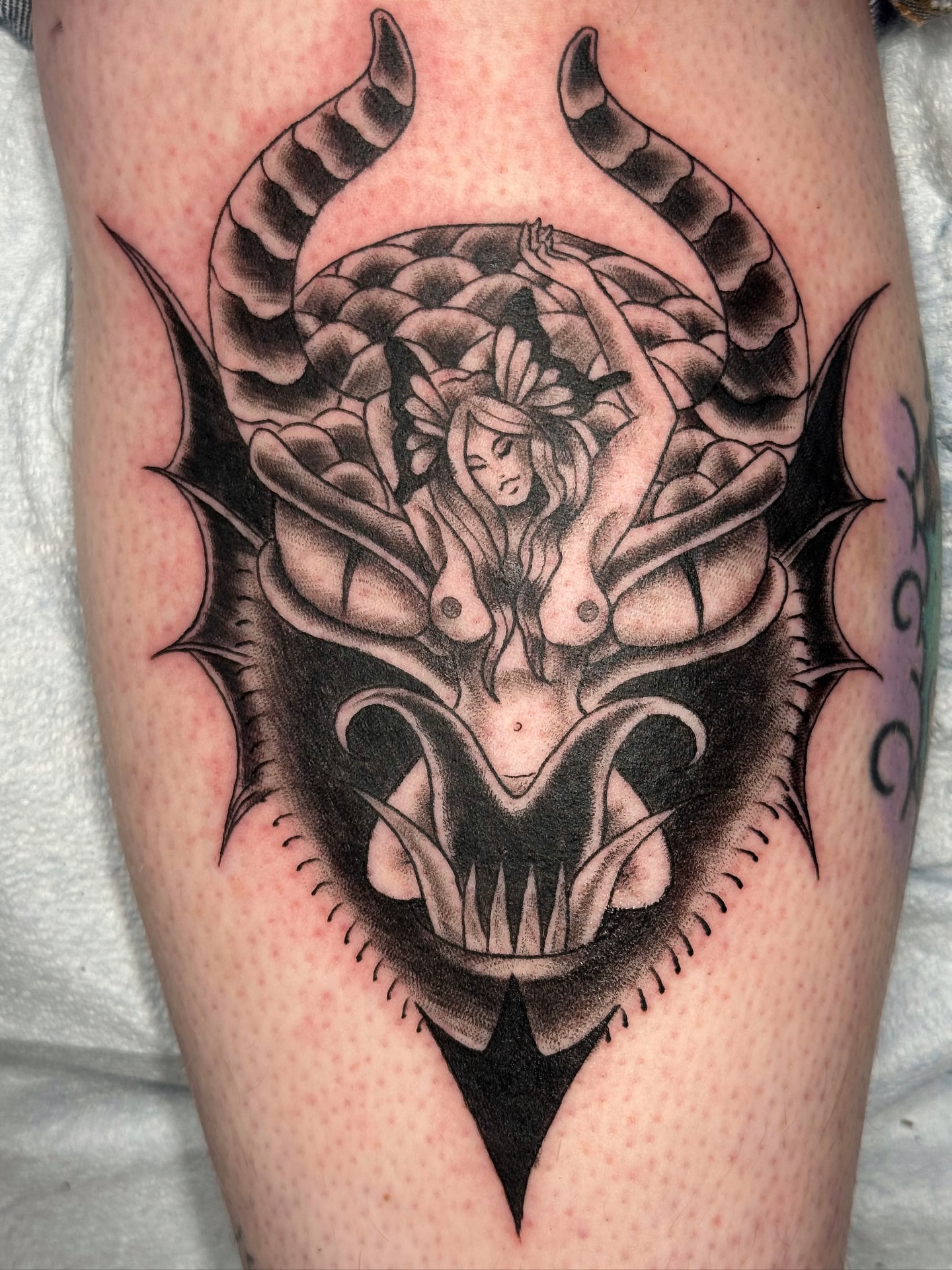 Demon with woman dark realism tattoo on the thigh by Rhiannon Ross, Lynnwood, Washington