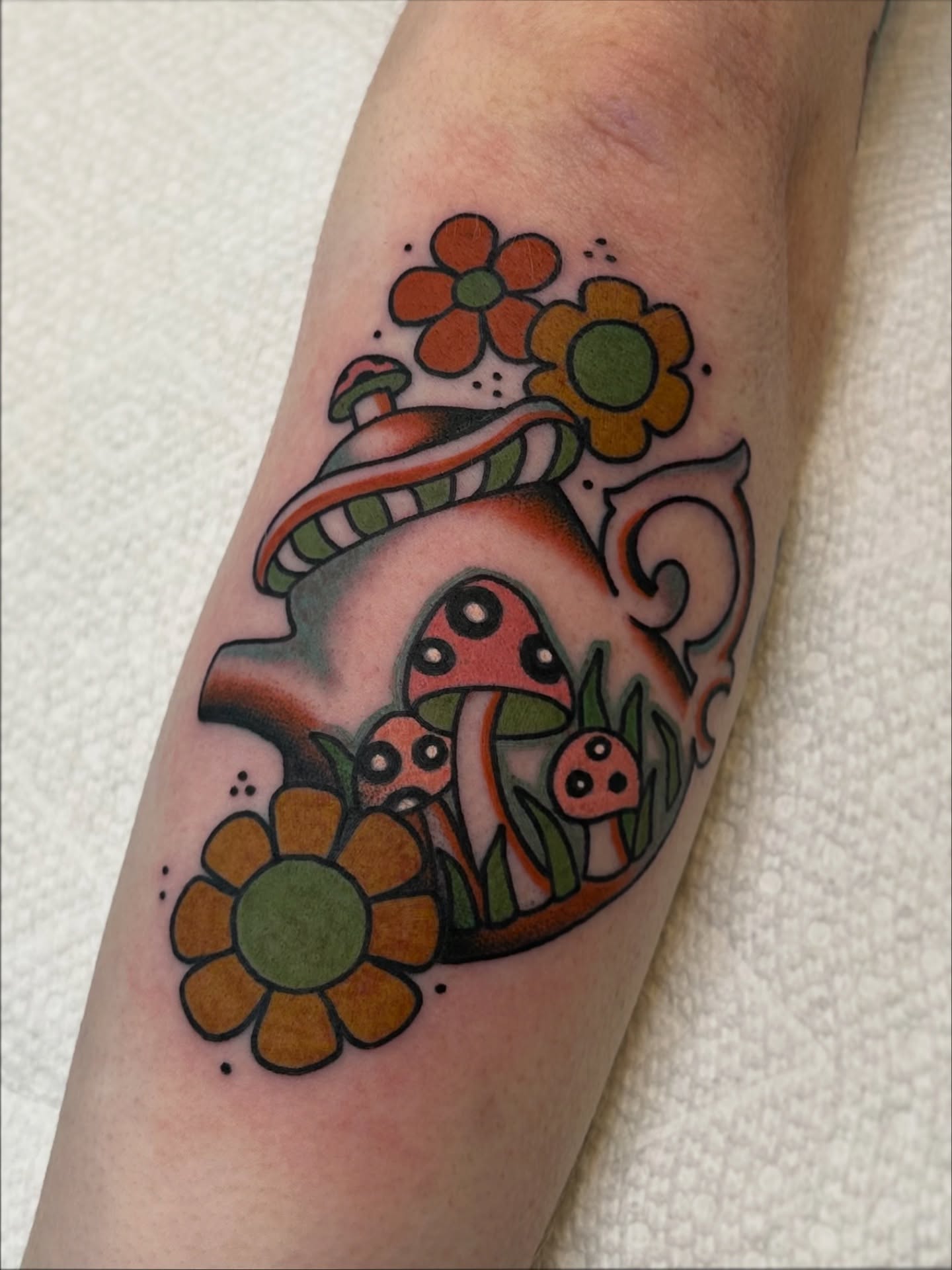 Mushroom and flowers new school tattoo on the forearm by Lauren Alexandra