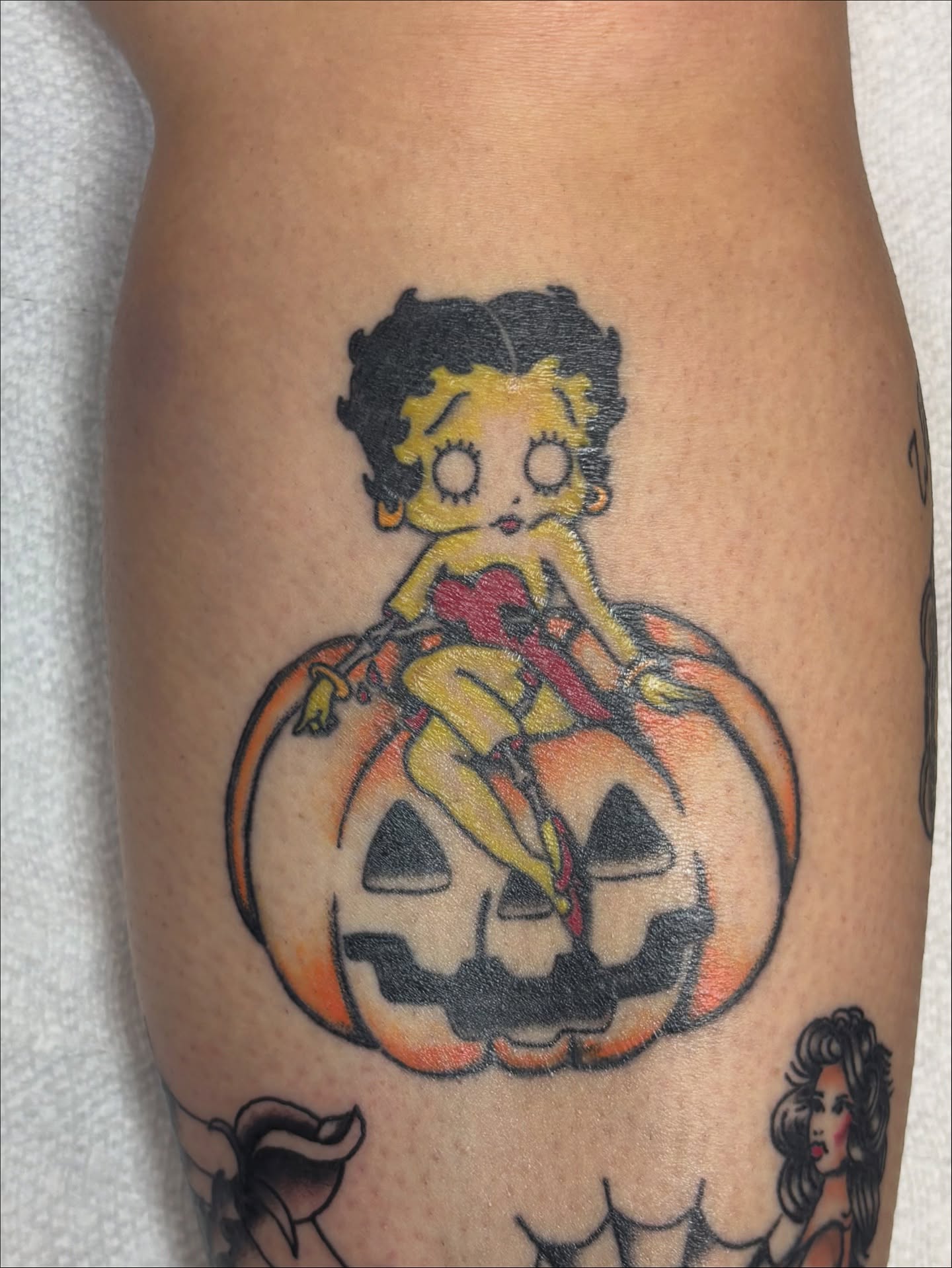 Betty Boop on pumpkin American traditional tattoo on the thigh by Bridget Smith