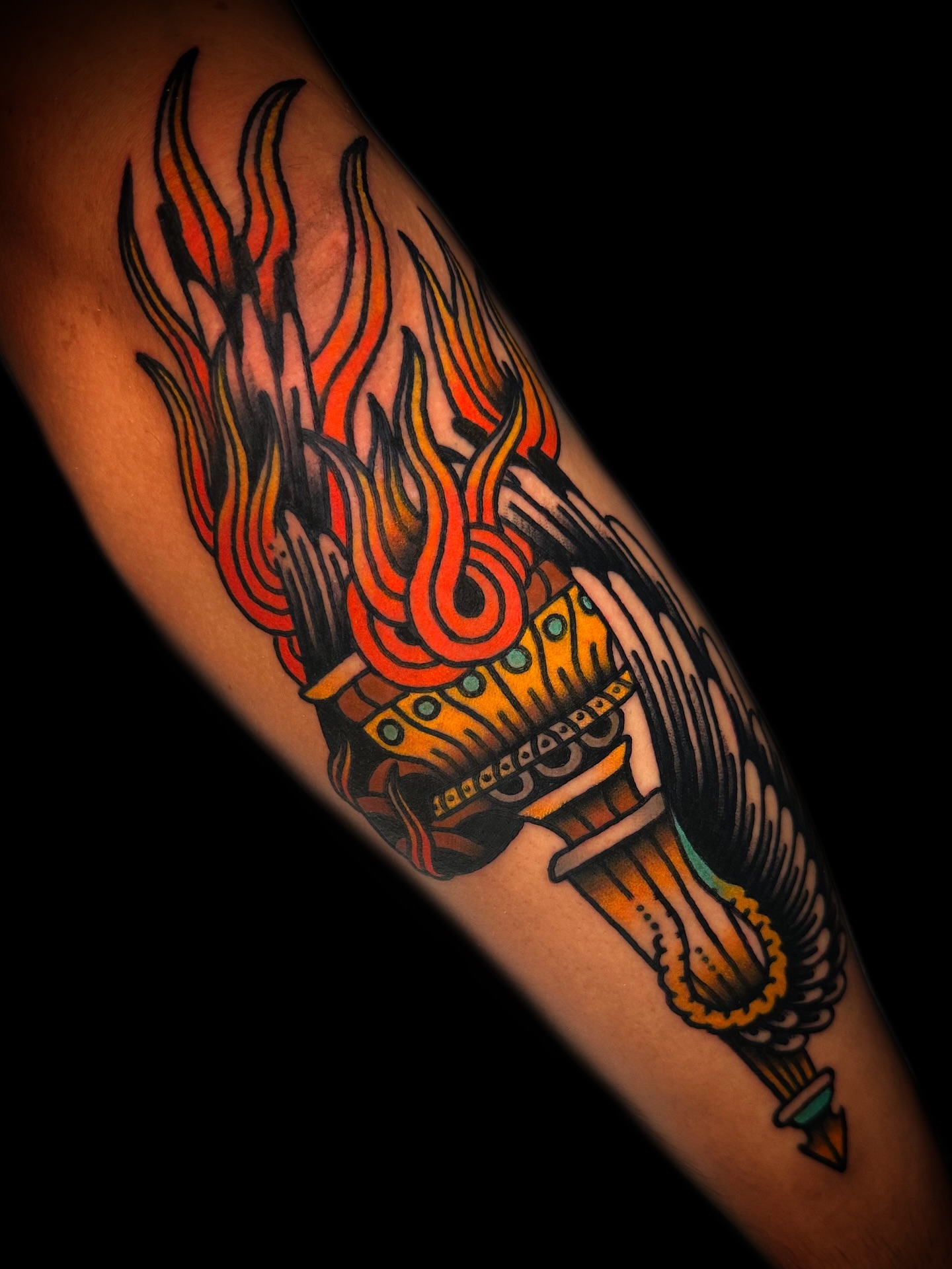 Flame and torch American traditional tattoo on the forearm by Danny Reis