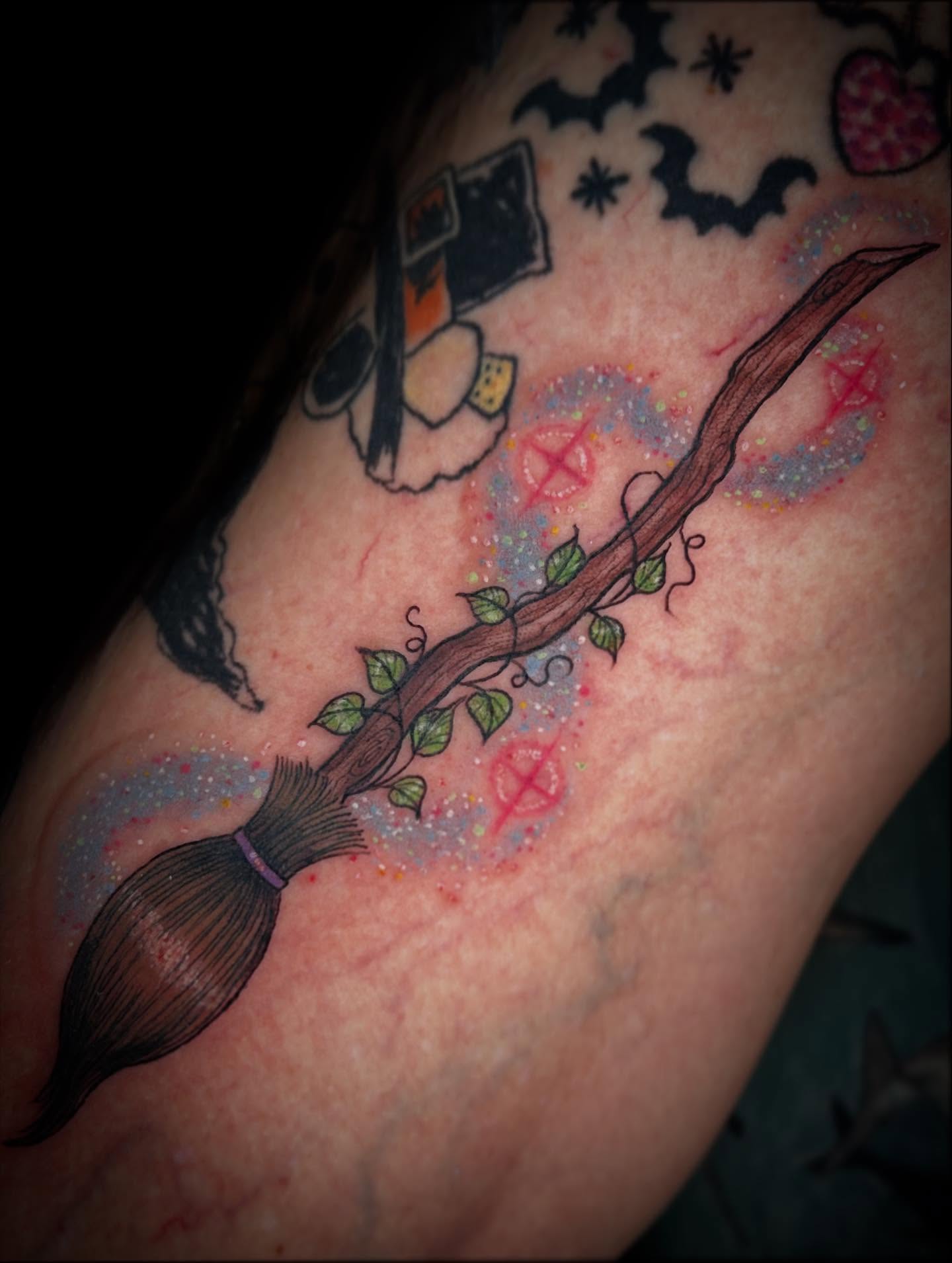 Broomstick with vines new school tattoo on the forearm by Ashlee Mshar
