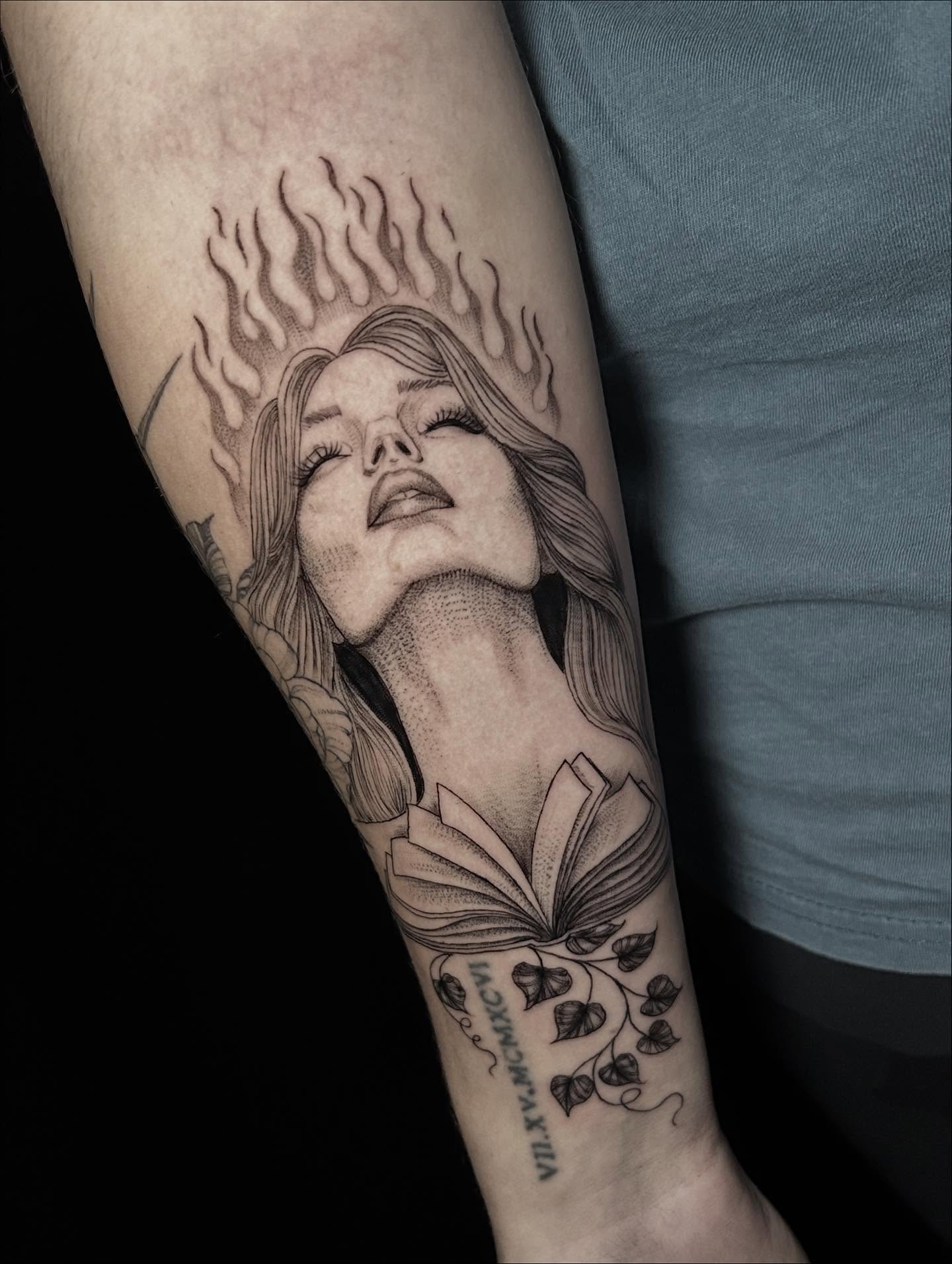 Woman with flames realism tattoo on the forearm by Ashlee Mshar