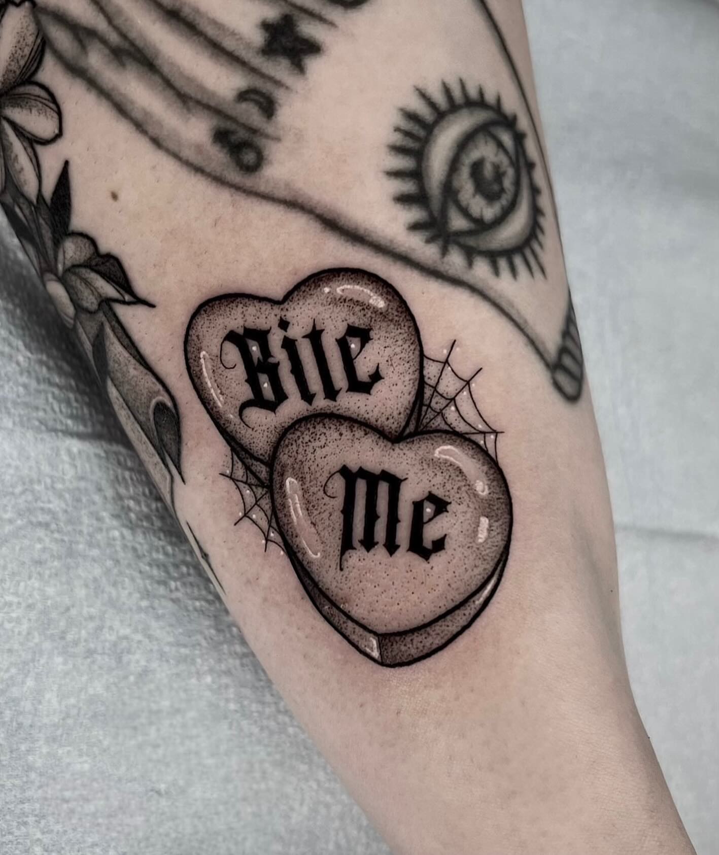 Hearts with text black and grey tattoo on the forearm by 𝔅𝔯𝔦 𝔉𝔩𝔢𝔱𝔠𝔥𝔢𝔯