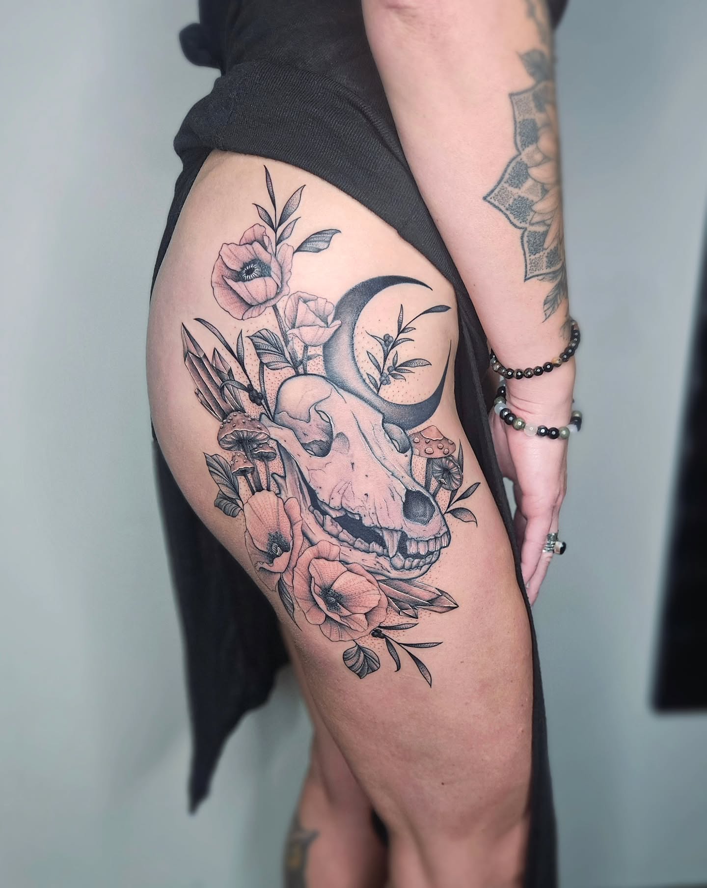 Skull and flowers black and grey tattoo on the thigh by TaylorLeighShermanTattoos OFFICIAL