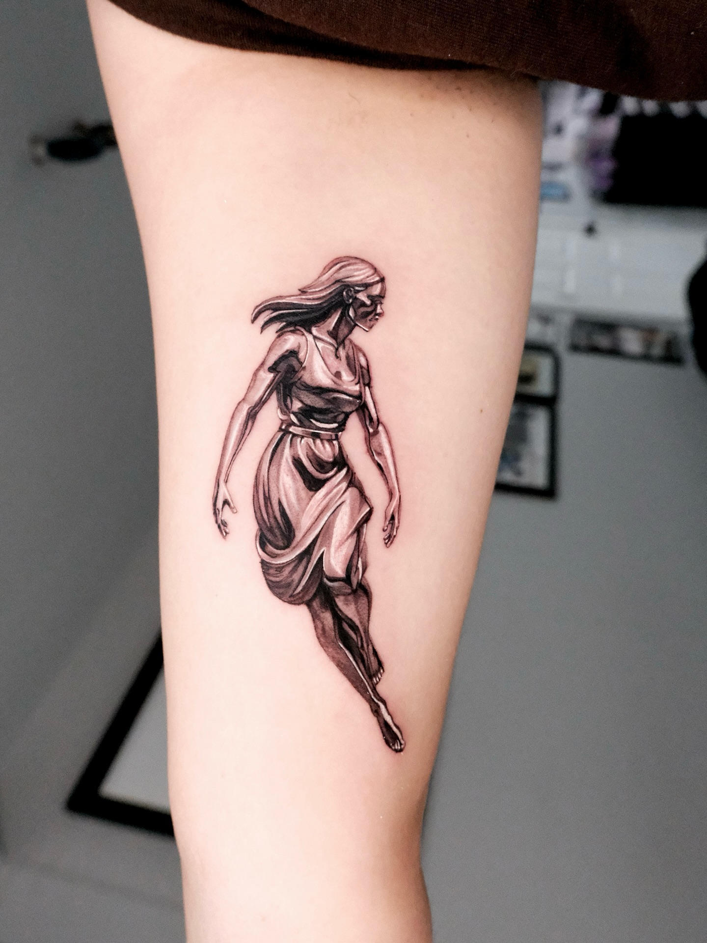 Woman in flowing dress black and grey tattoo on the thigh by Bay Area Tattoo Artist