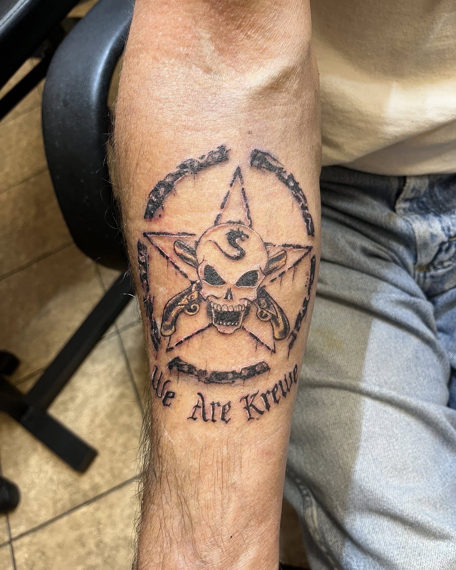 Pentagram with skull and crossbones black and grey tattoo on the forearm by Jessica DarkRabbit