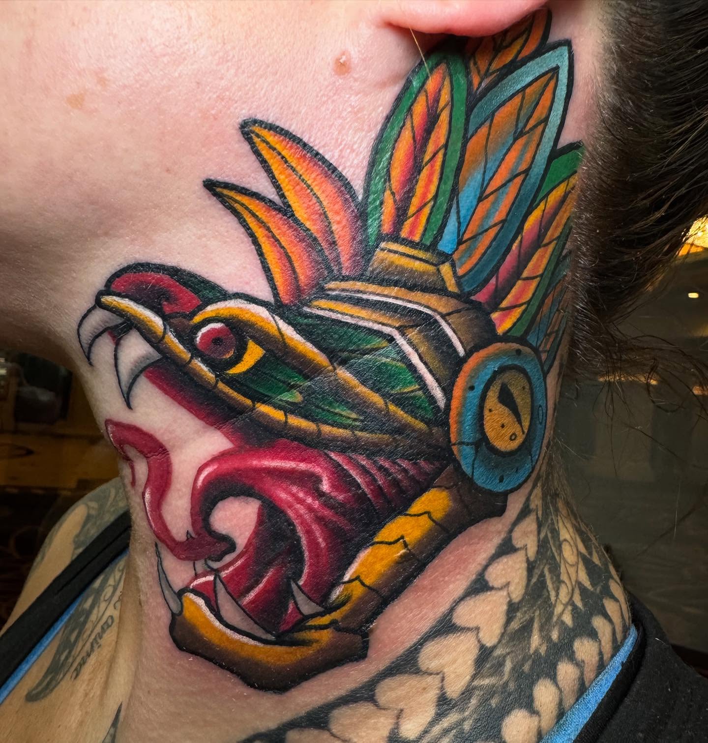 Serpent head American traditional tattoo on the neck by Brian Herrera