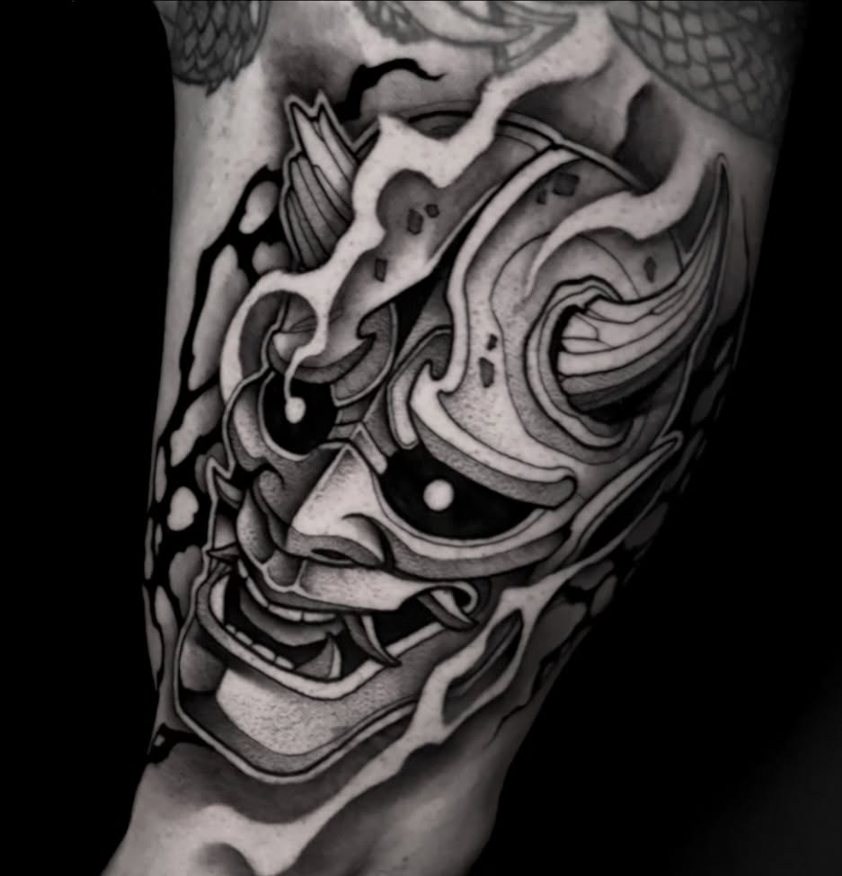 Demon mask black and grey tattoo on the forearm by Clayton Smith (BEAR)