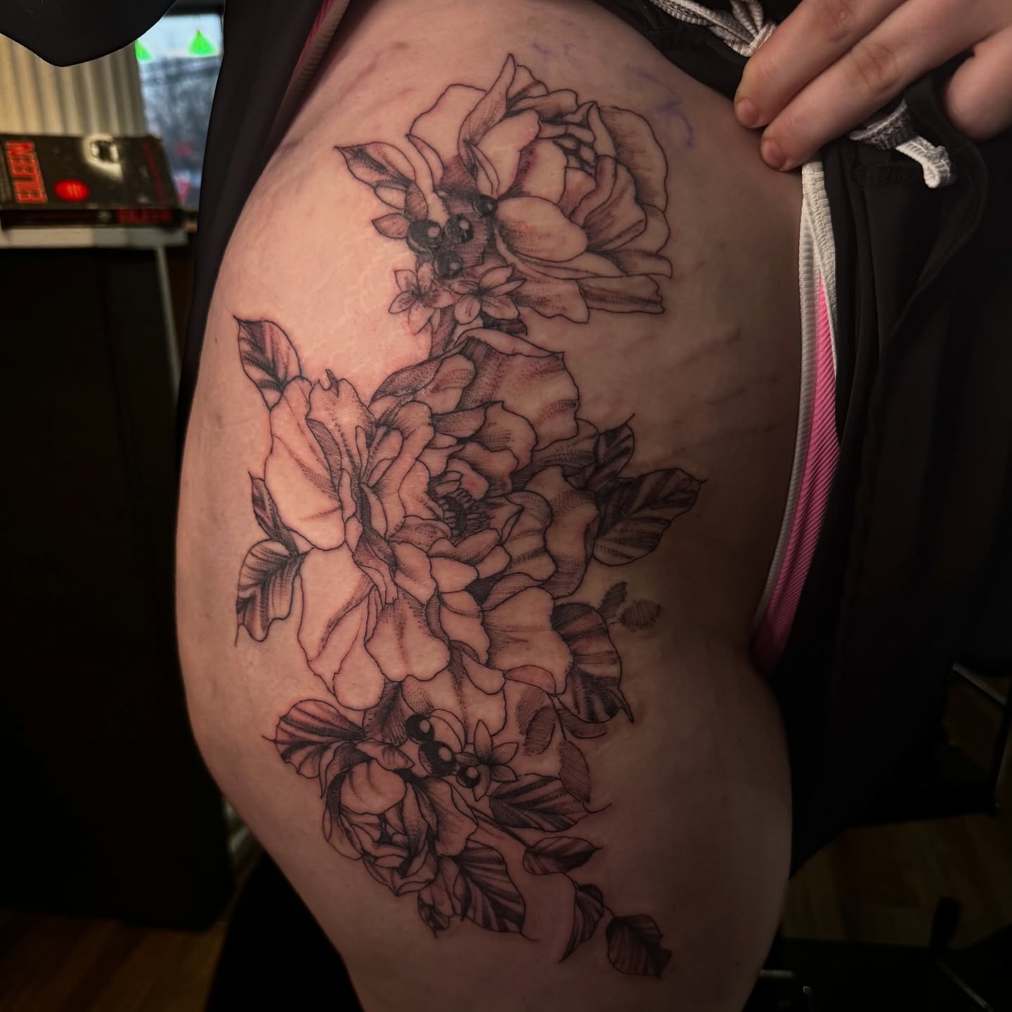 Floral bouquet black and grey tattoo on the thigh by Lexy