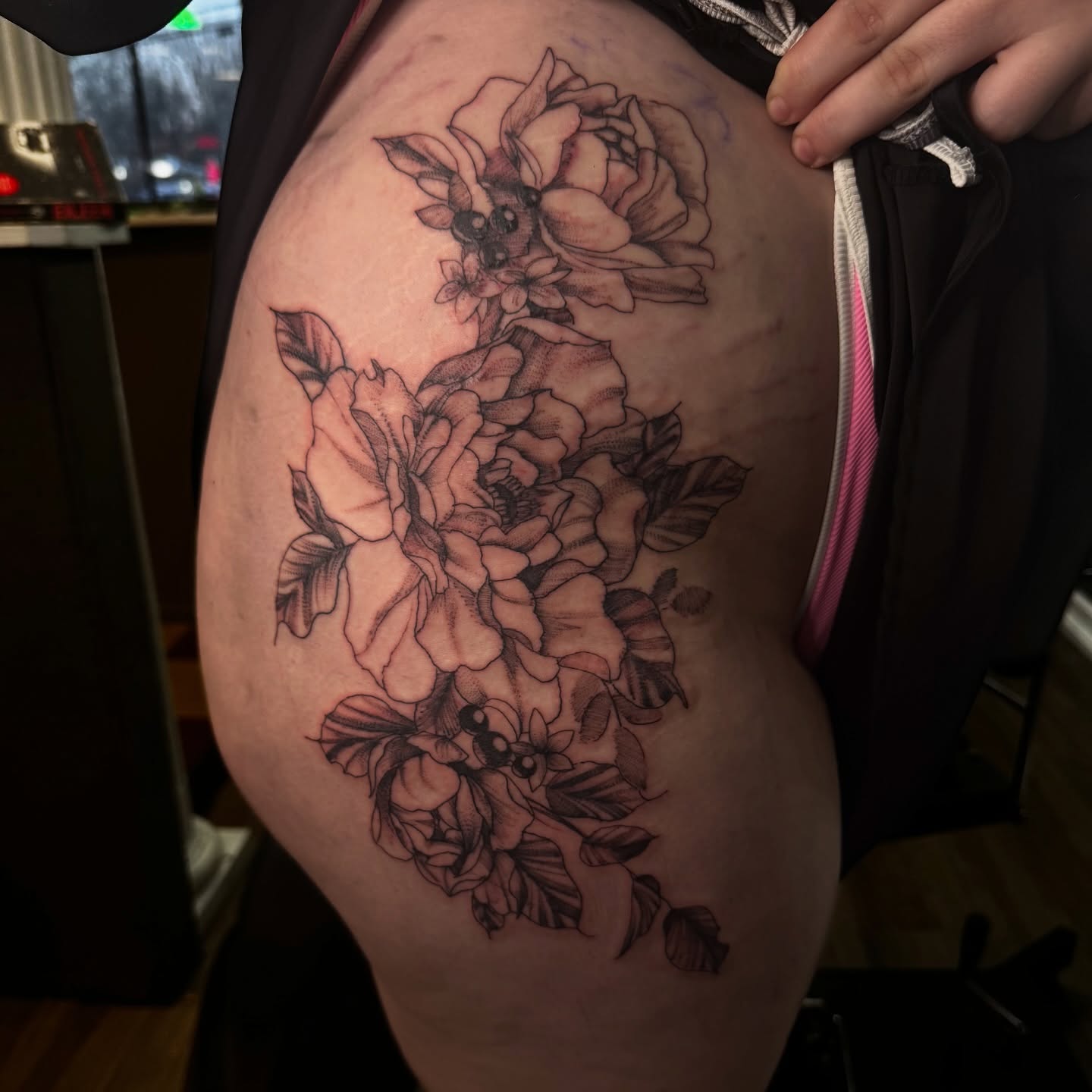 Floral bouquet black and grey tattoo on the thigh by Lexy