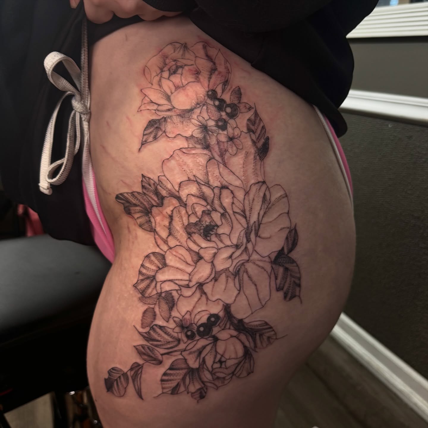 Floral bouquet black and grey tattoo on the thigh by Lexy