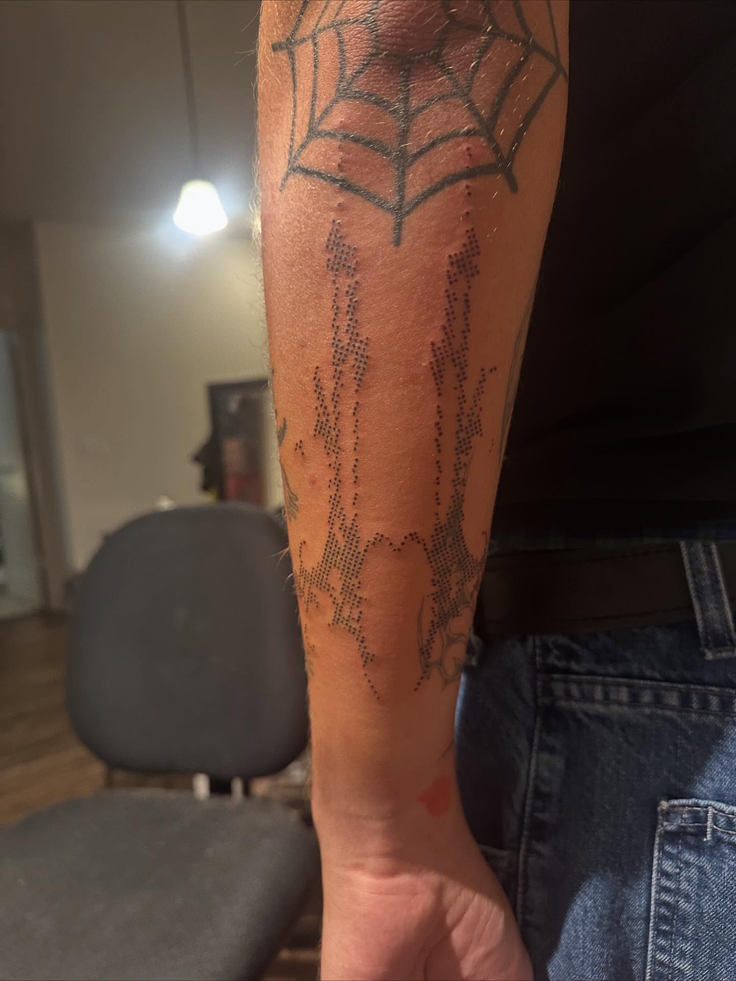 Spider web dotwork tattoo on the forearm by Swag Originator