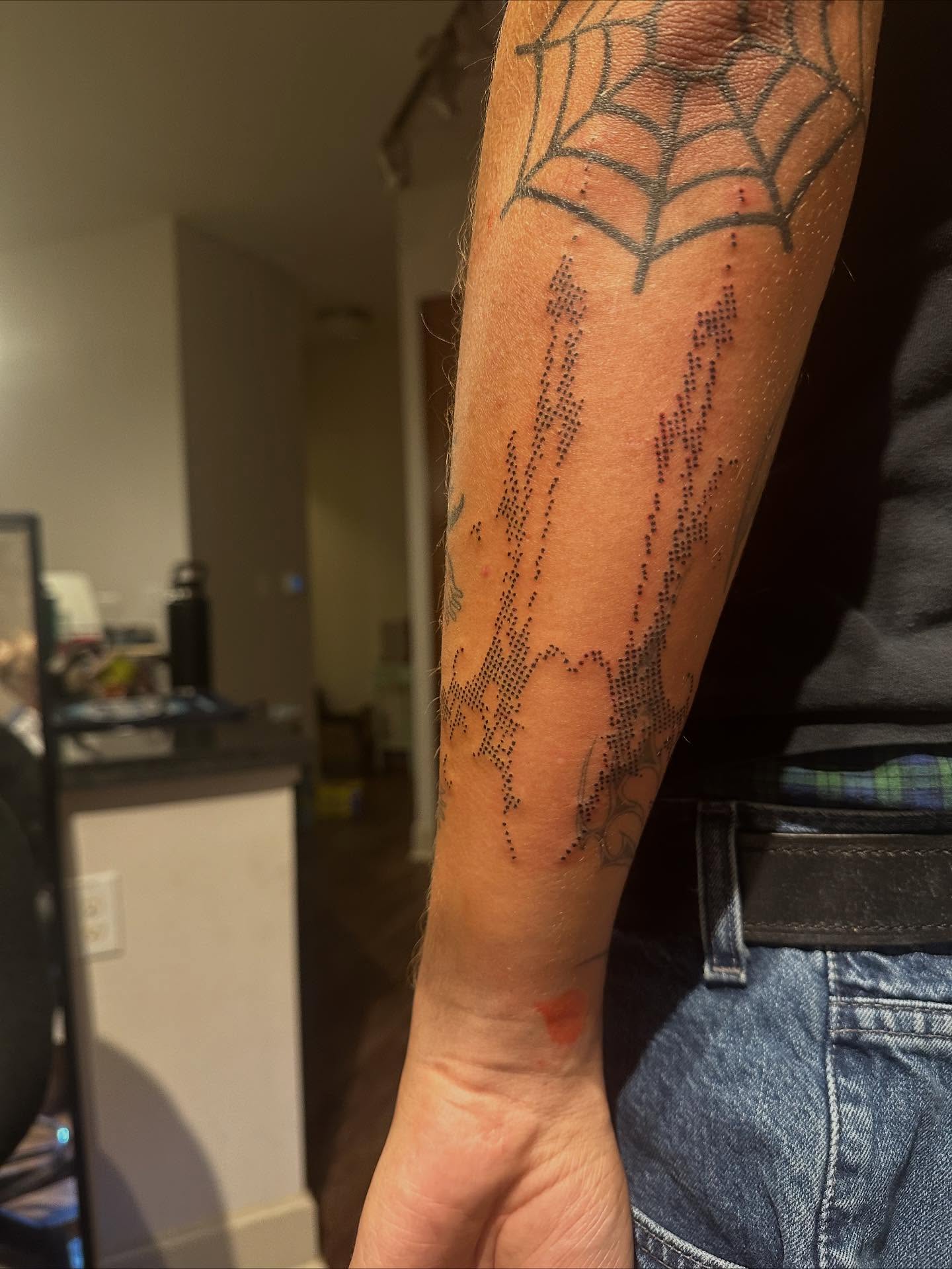 Spider web dotwork tattoo on the forearm by Swag Originator
