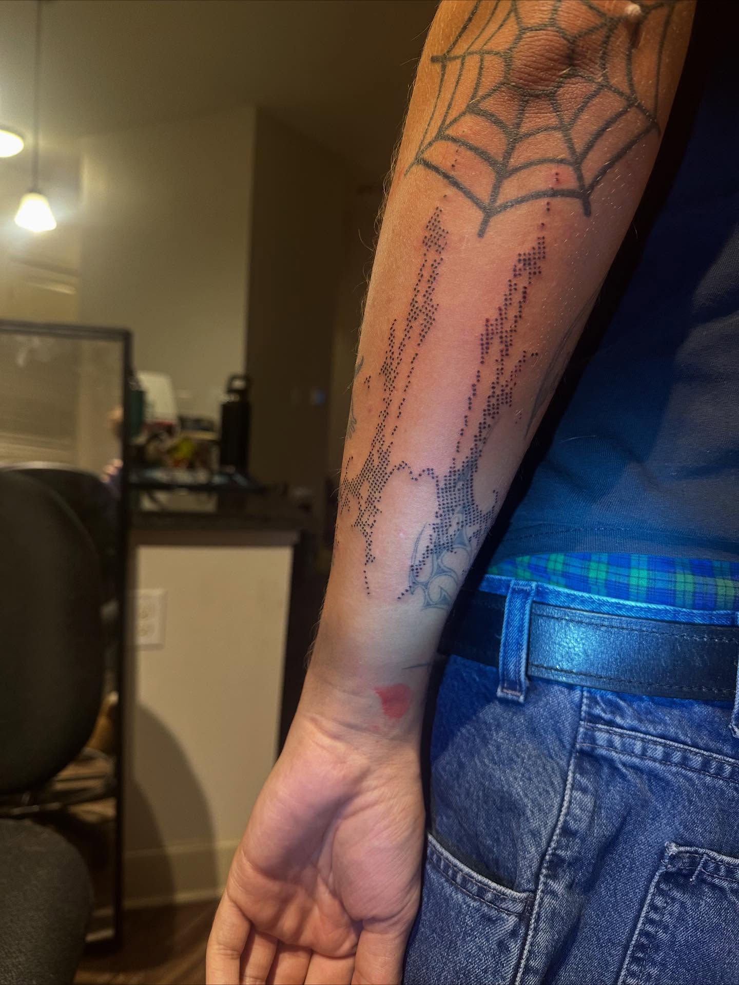 Spiderweb dotwork tattoo on the forearm by Swag Originator