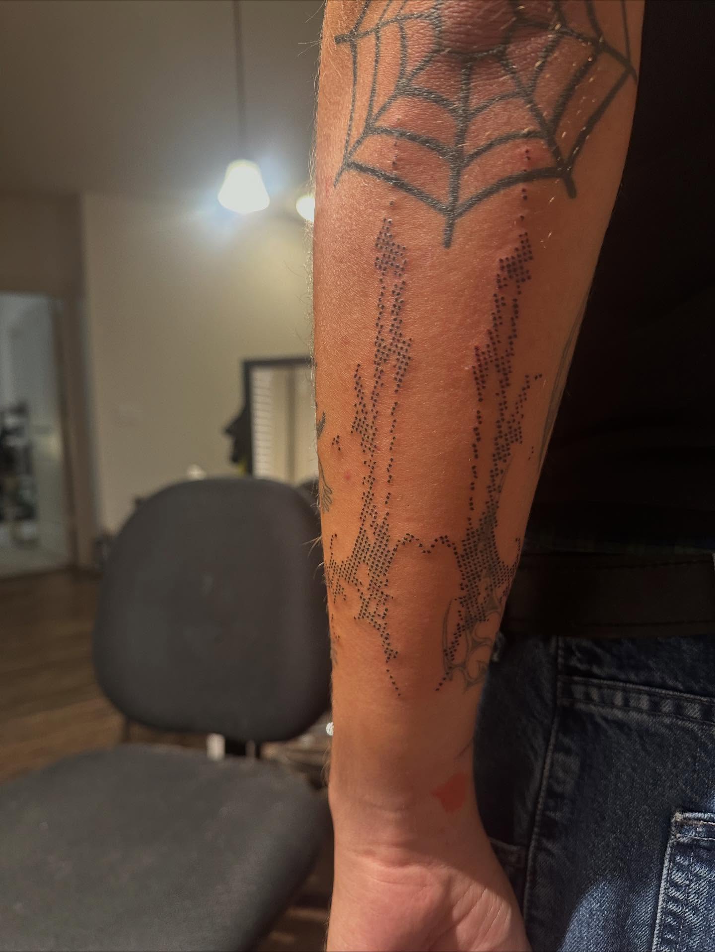 Spider web dotwork tattoo on the forearm by Swag Originator
