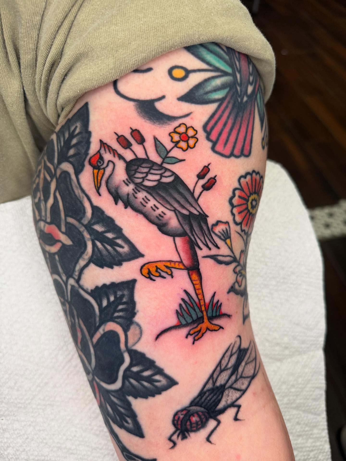 Bird and flowers American traditional tattoo on the forearm by Cody Petkus