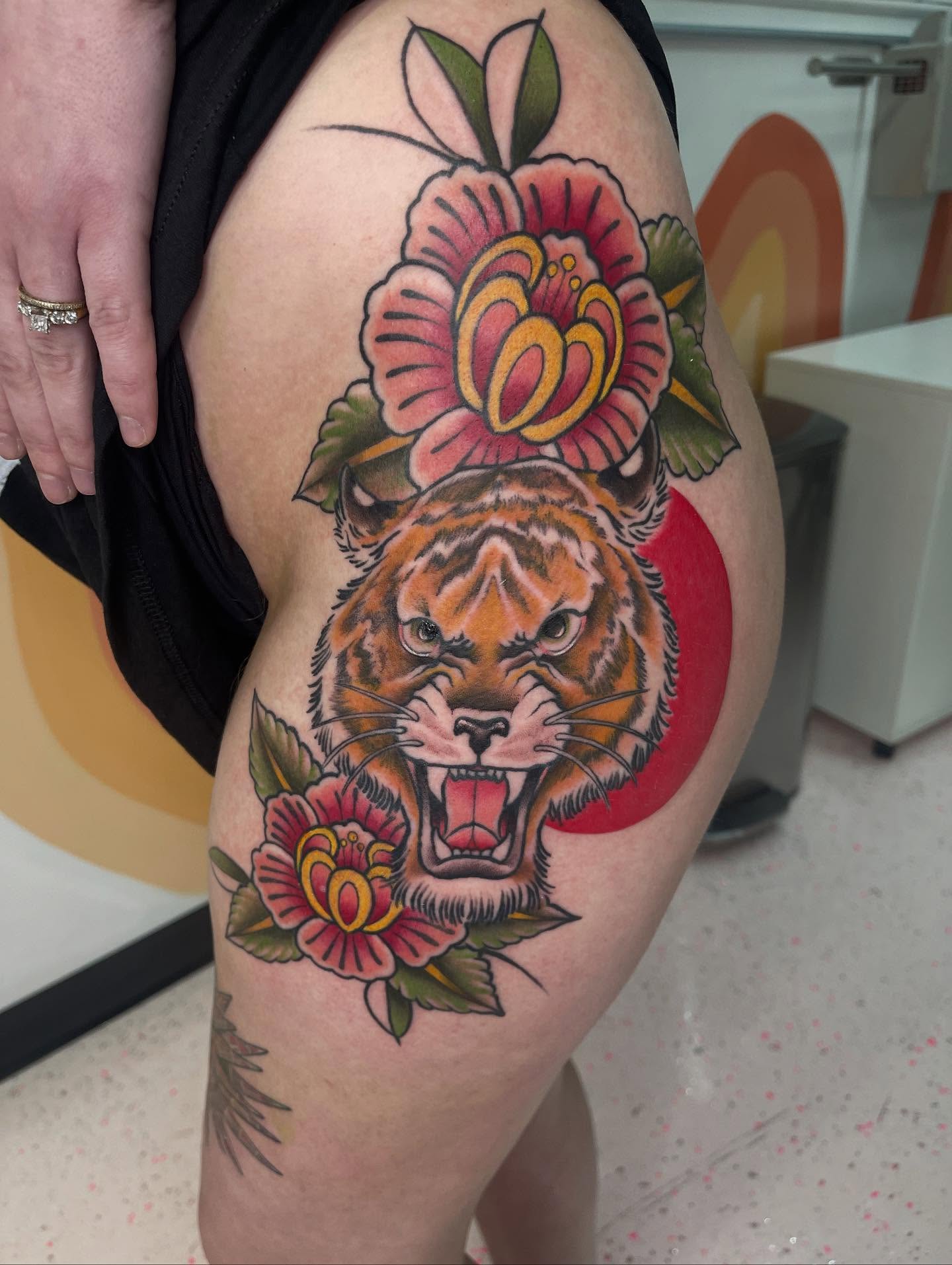 Tiger and flowers American traditional tattoo on the thigh by Allison Gallagher