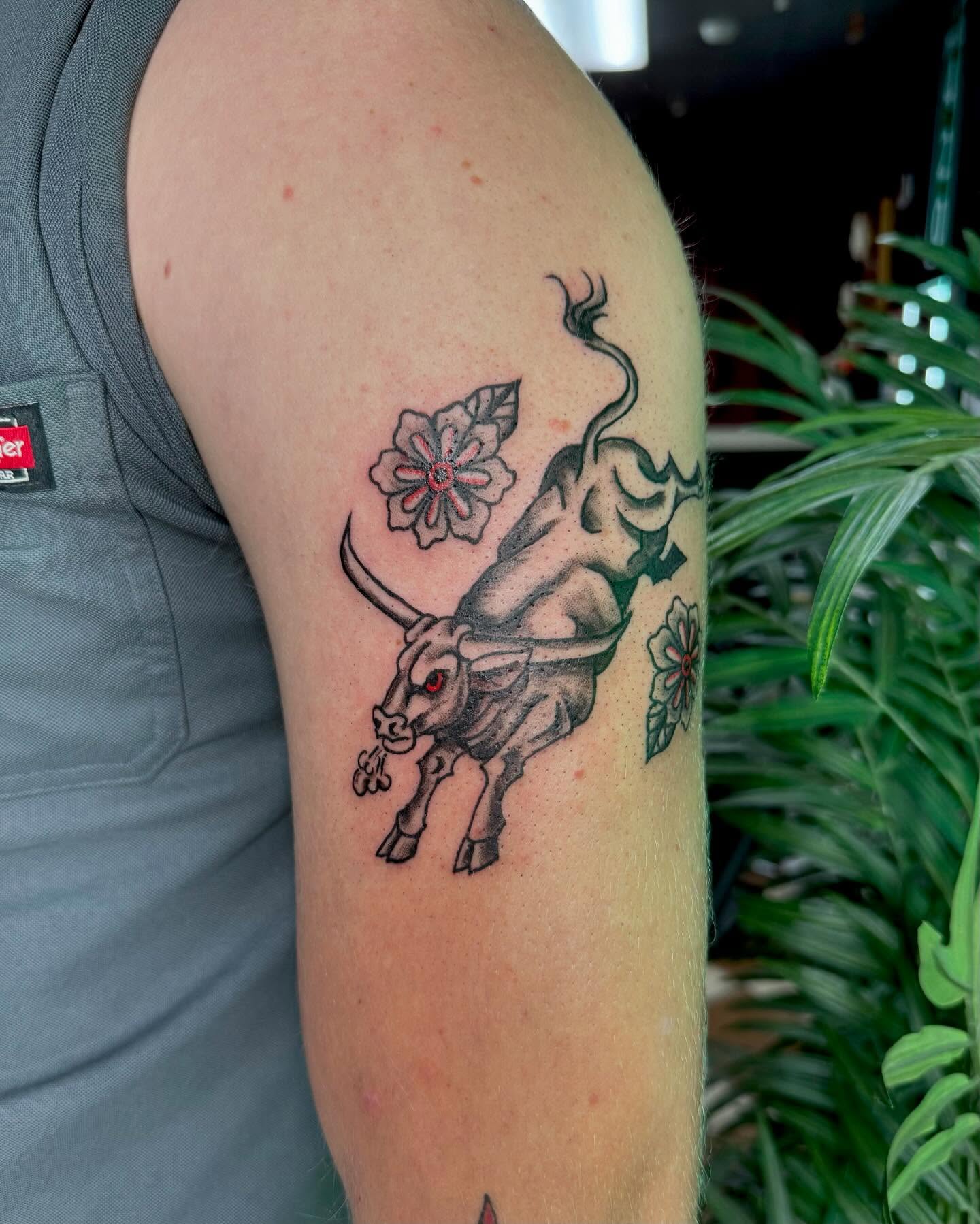 Bull and flowers American traditional tattoo on the forearm by Nina Rush