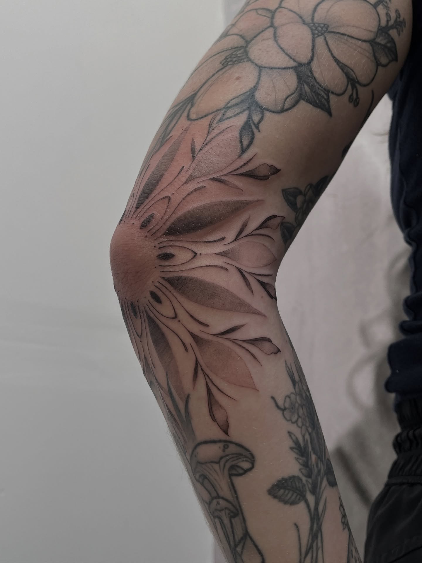 Floral design black and grey tattoo on the forearm by Lo Gwynn