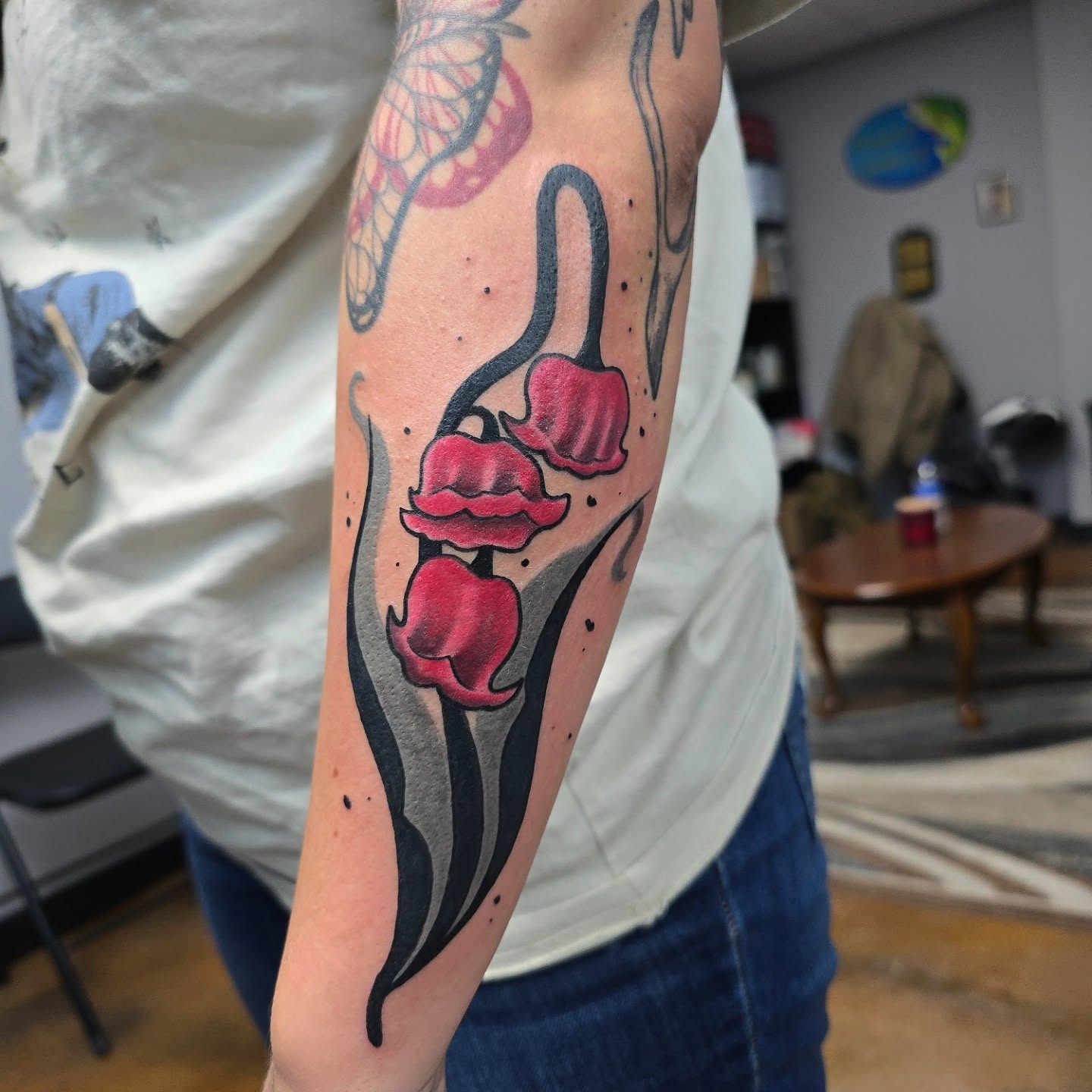 Lilies American traditional tattoo on the forearm by Jon Griffin, Maryville, Tennessee