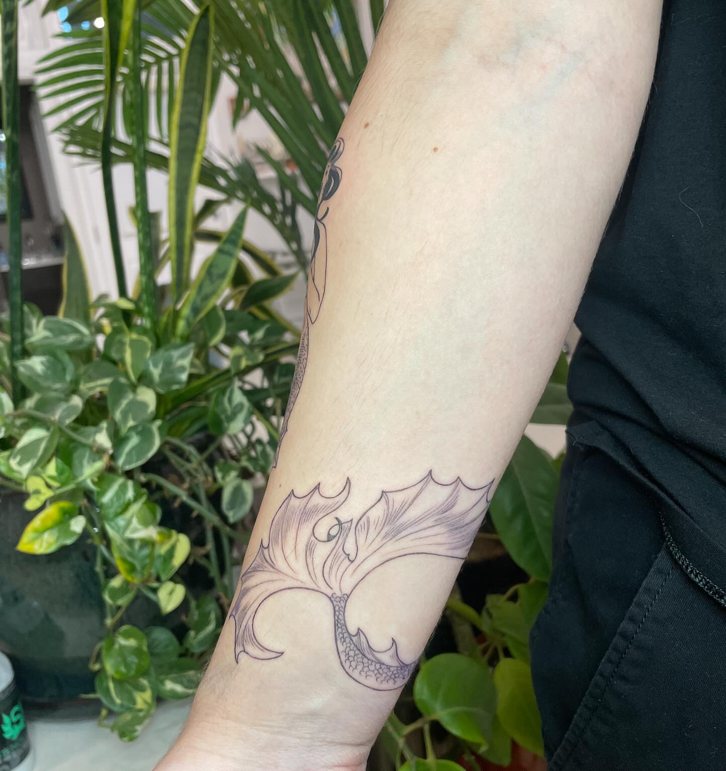 Winged dragon black and grey tattoo on the forearm by Ally Easter, Berkeley, California