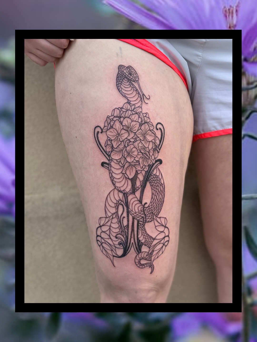 Snake and flowers black and grey tattoo on the thigh by Sydney