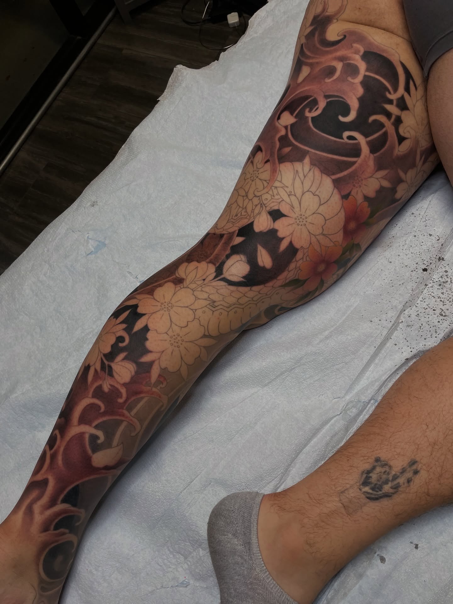 Floral design japanese irezumi tattoo on the calf by <