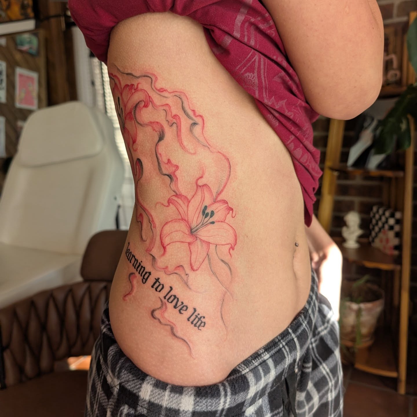 Lily and flame new school tattoo on the ribs by Arminda Walborn