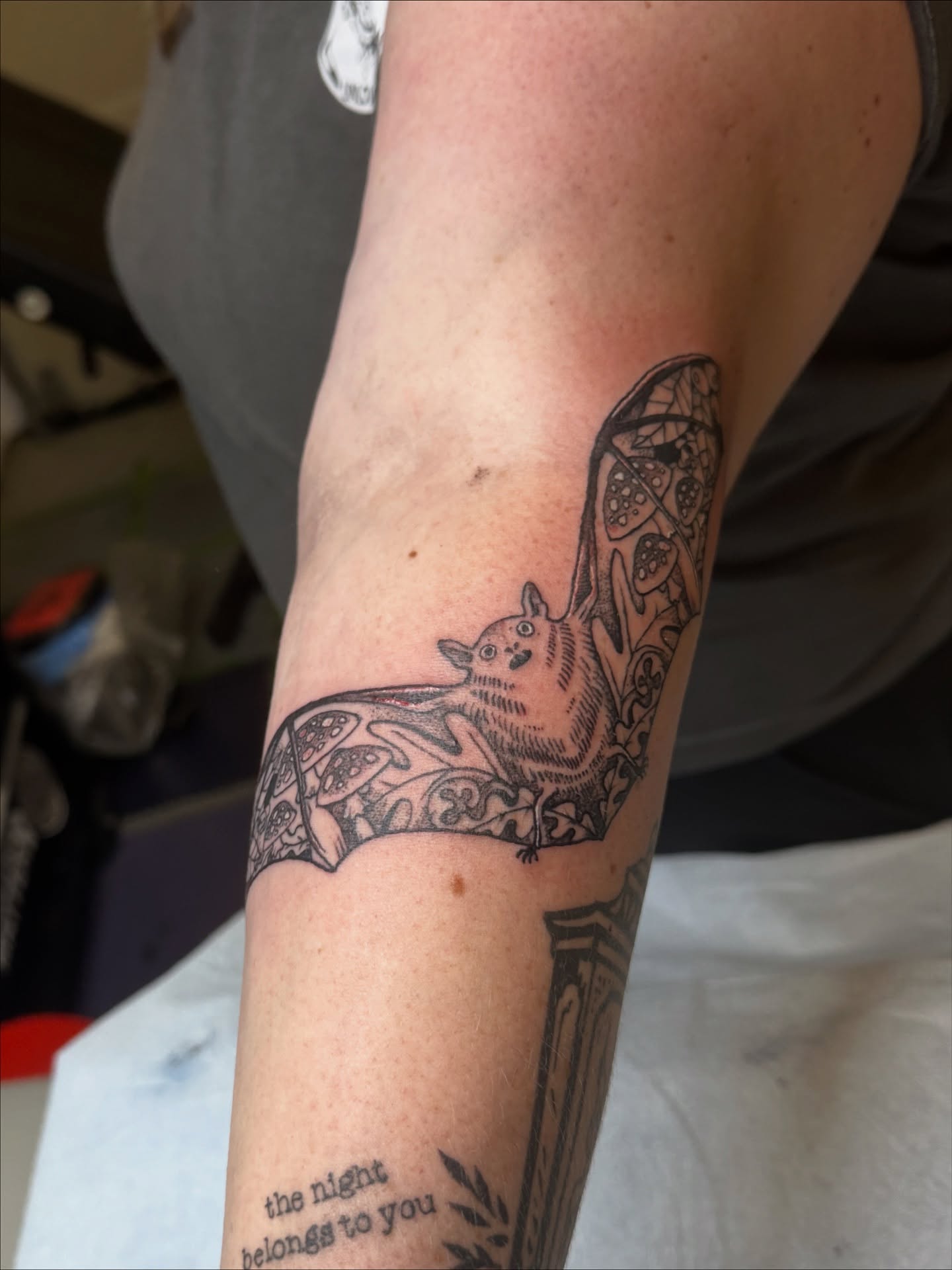 Bat black and grey tattoo on the forearm by Emma Berger