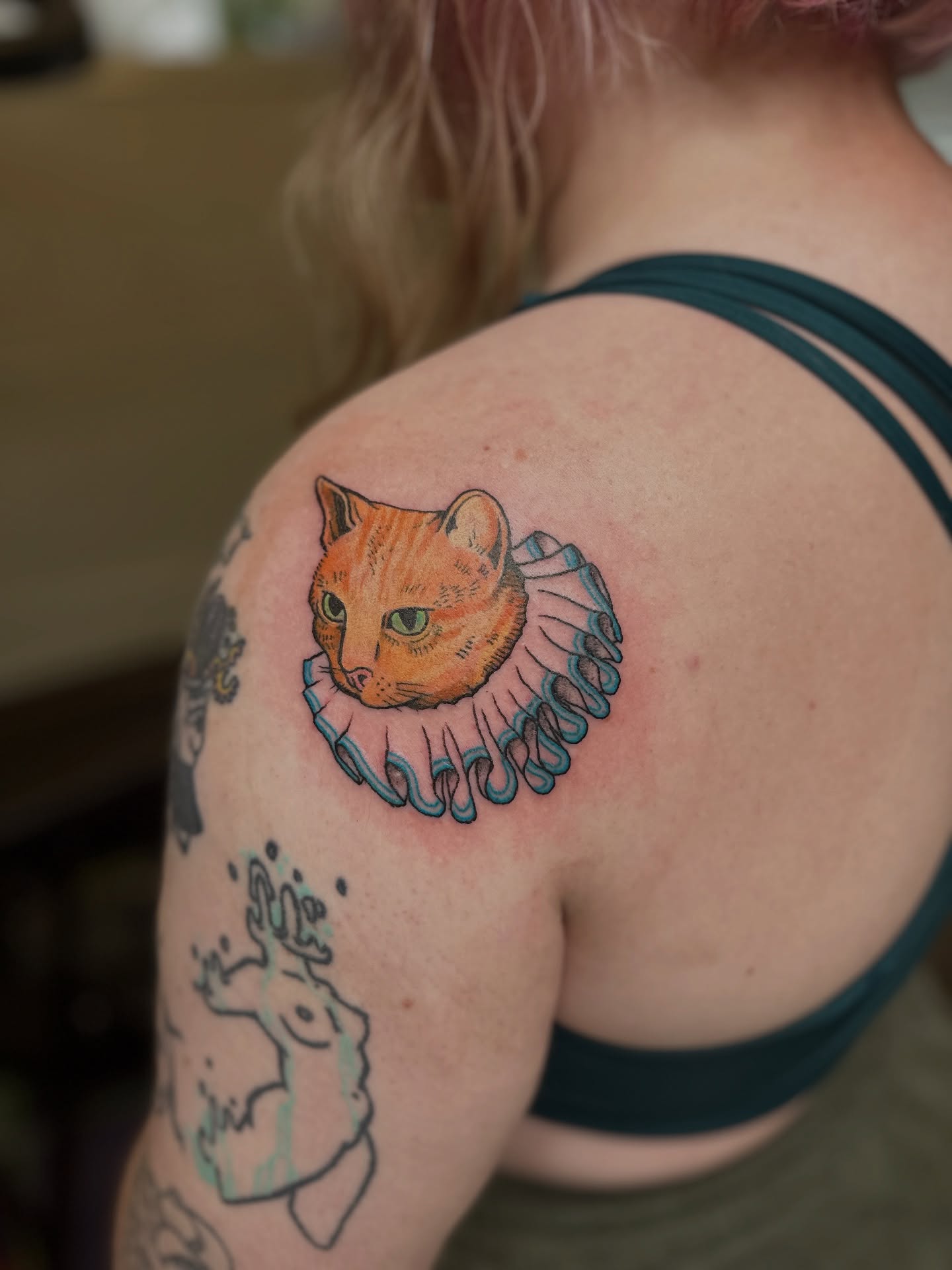 Cat with ruff realism tattoo on the shoulder by Emma Berger