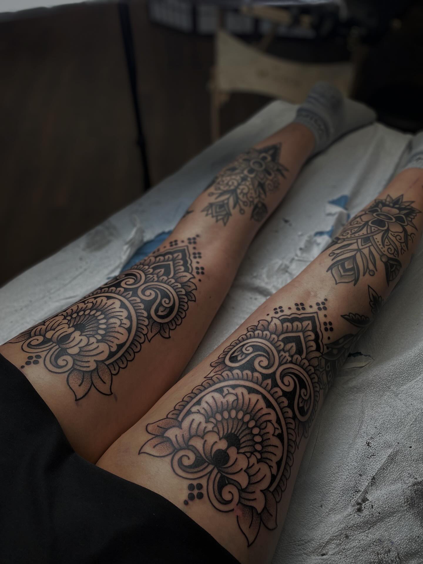 Floral mandala black and grey tattoo on the leg by Veronica