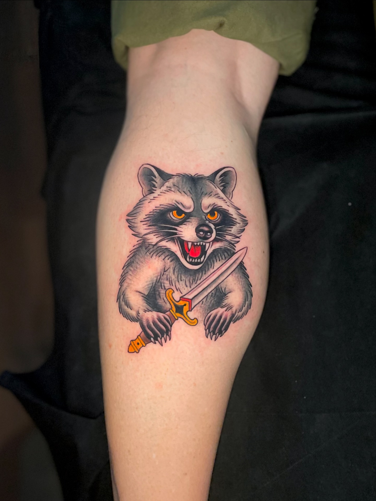 Raccoon with sword American traditional tattoo on the forearm by Ｊｉｍ Ｓｙｌｖｉａ