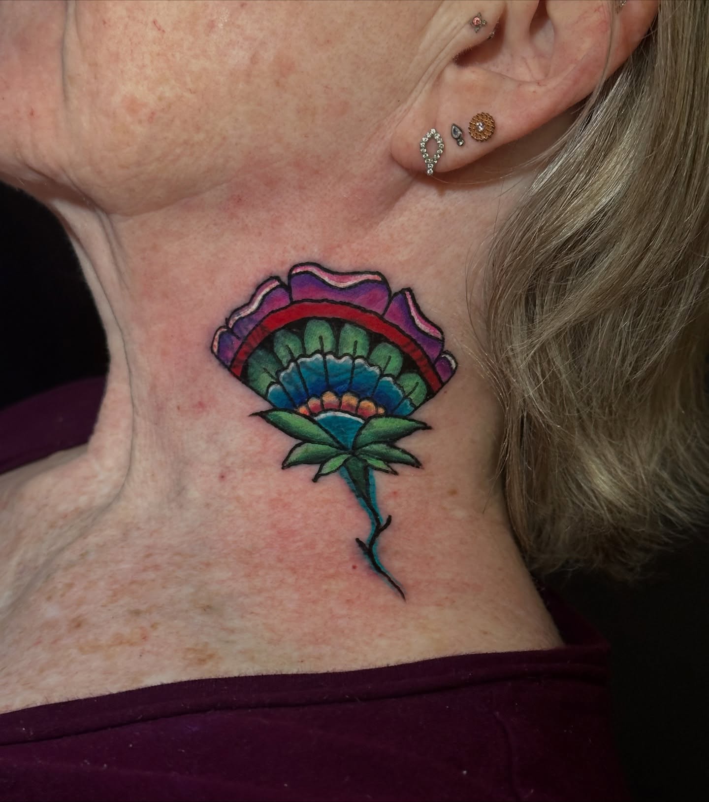 Flower American traditional tattoo on the neck by Cory Wasmund (blue check)