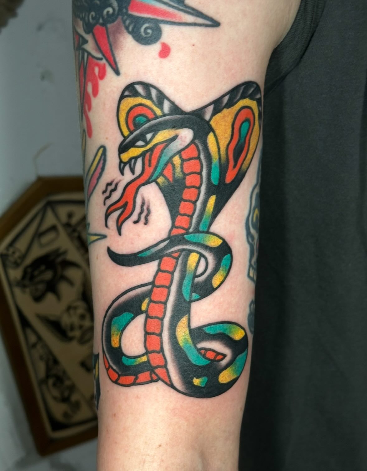 Snake American traditional tattoo on the forearm by Steve Pearson